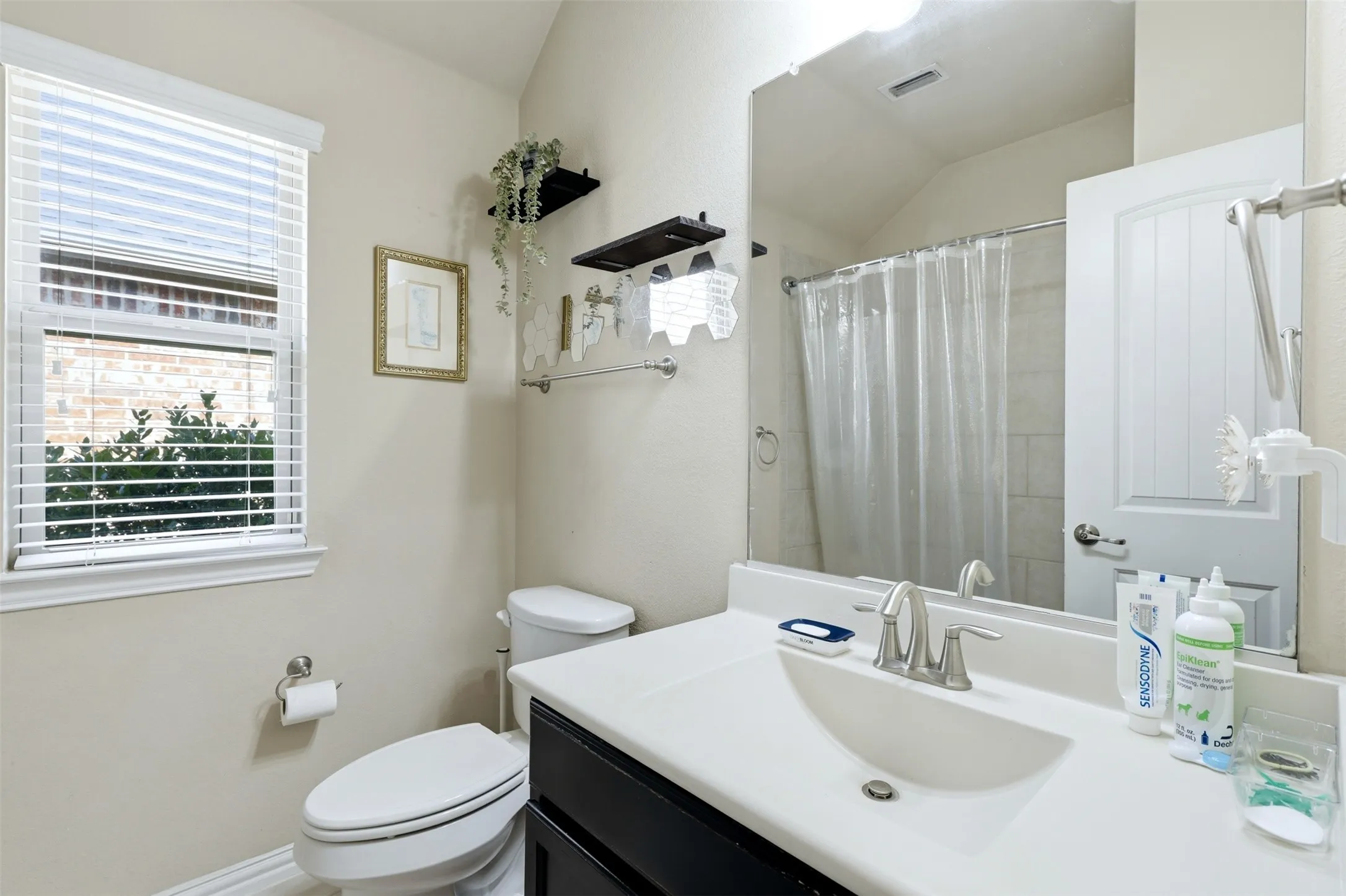 White bathroom vanity with an integrated sink and brushed nickel faucet
