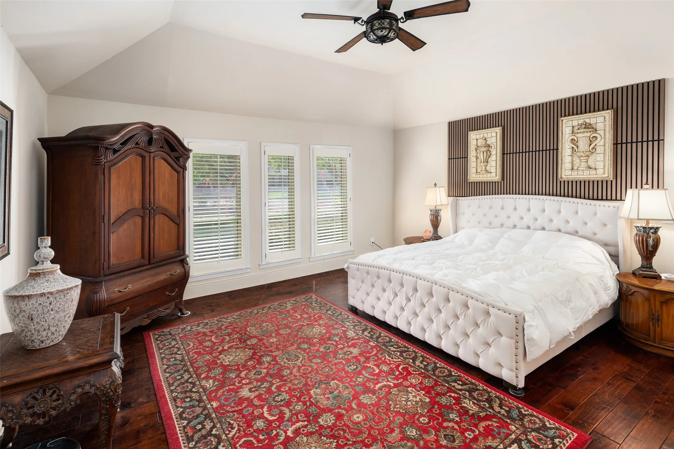 Master Bedroom featuring dark wood finished floors, vaulted ceiling, and ceiling fan
