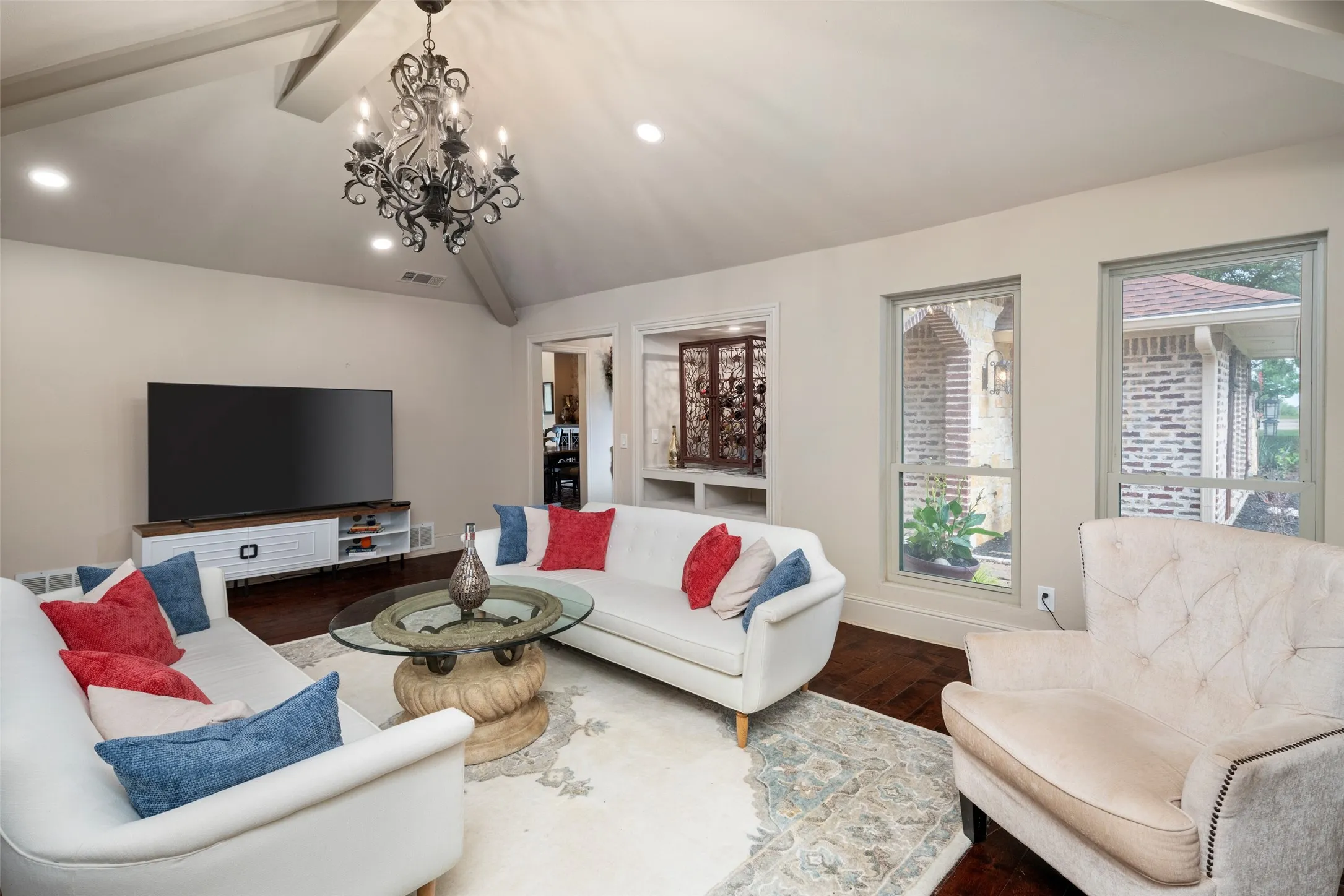 Living room featuring dark wood finished floors, a chandelier, recessed lighting, and baseboards