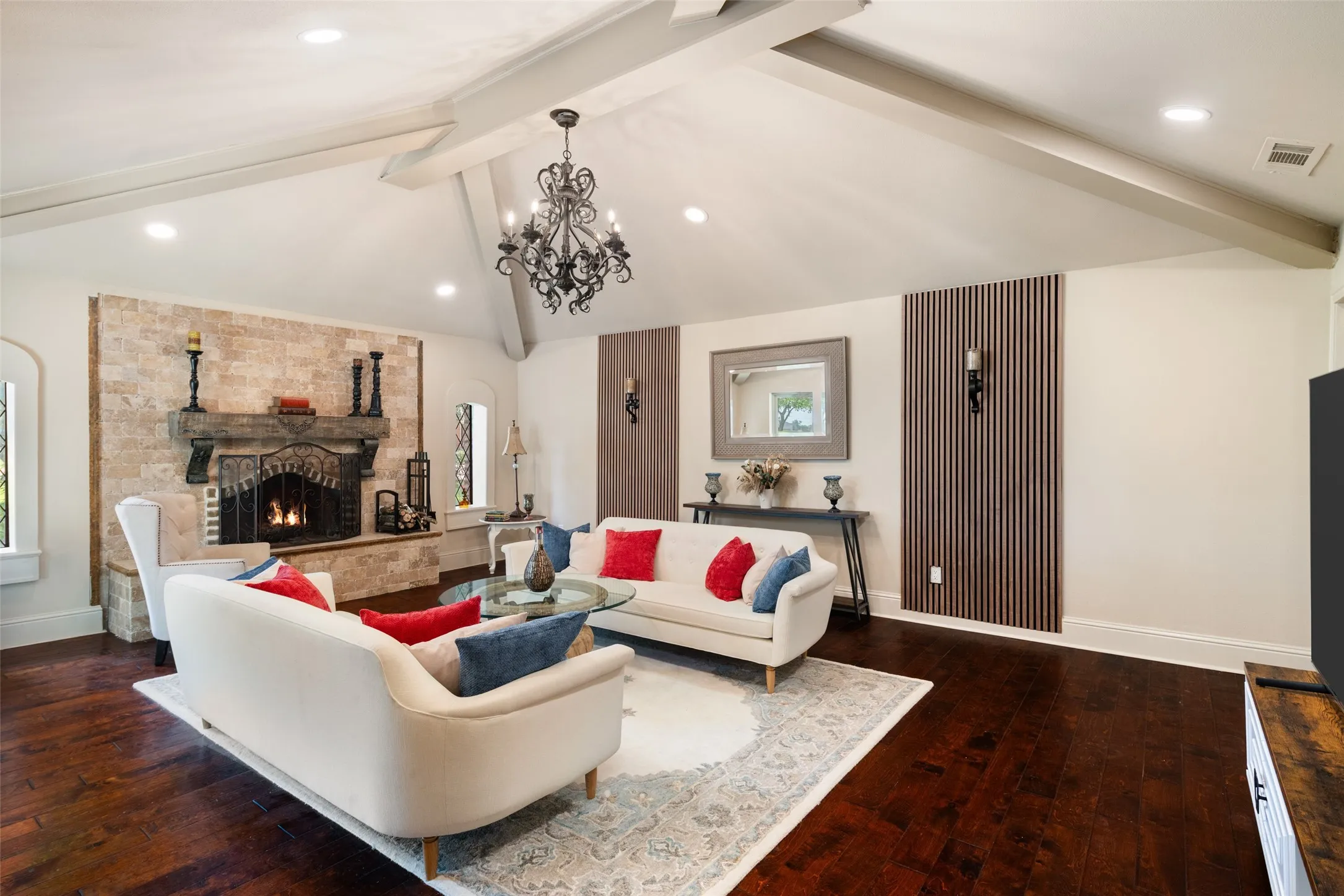 Living area featuring wood-type flooring, baseboards, a fireplace, a chandelier, and recessed lighting