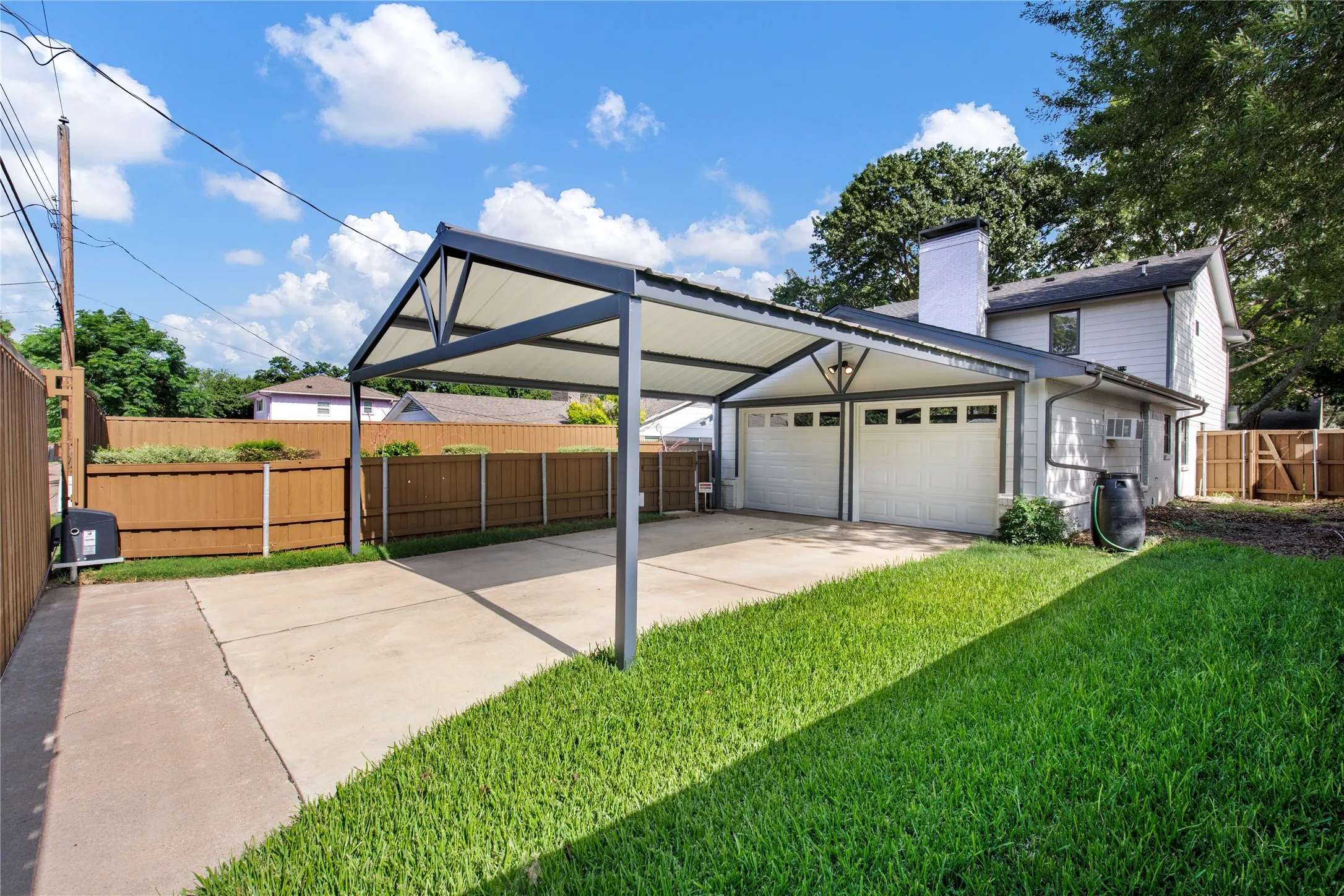 2 car garage with storage and carport