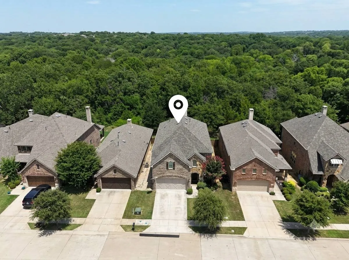 Brick exterior residence with a two-car garage and a paved driveway