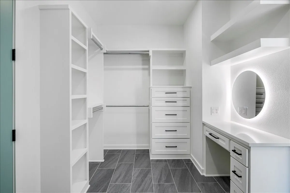 Custom closet system featuring built-in shelving, hanging rods, and integrated drawers