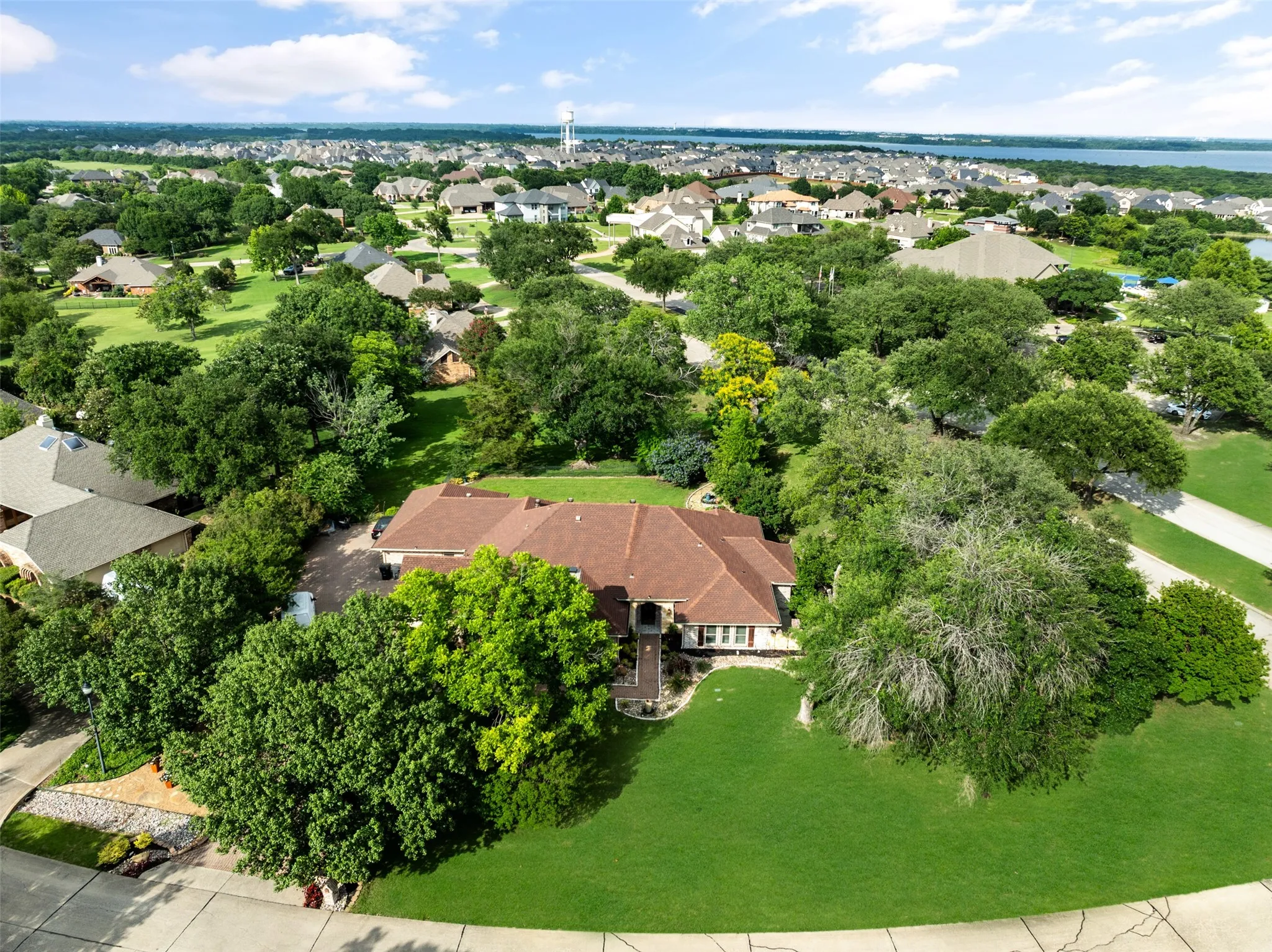 Aerial perspective of suburban area featuring a large body of water