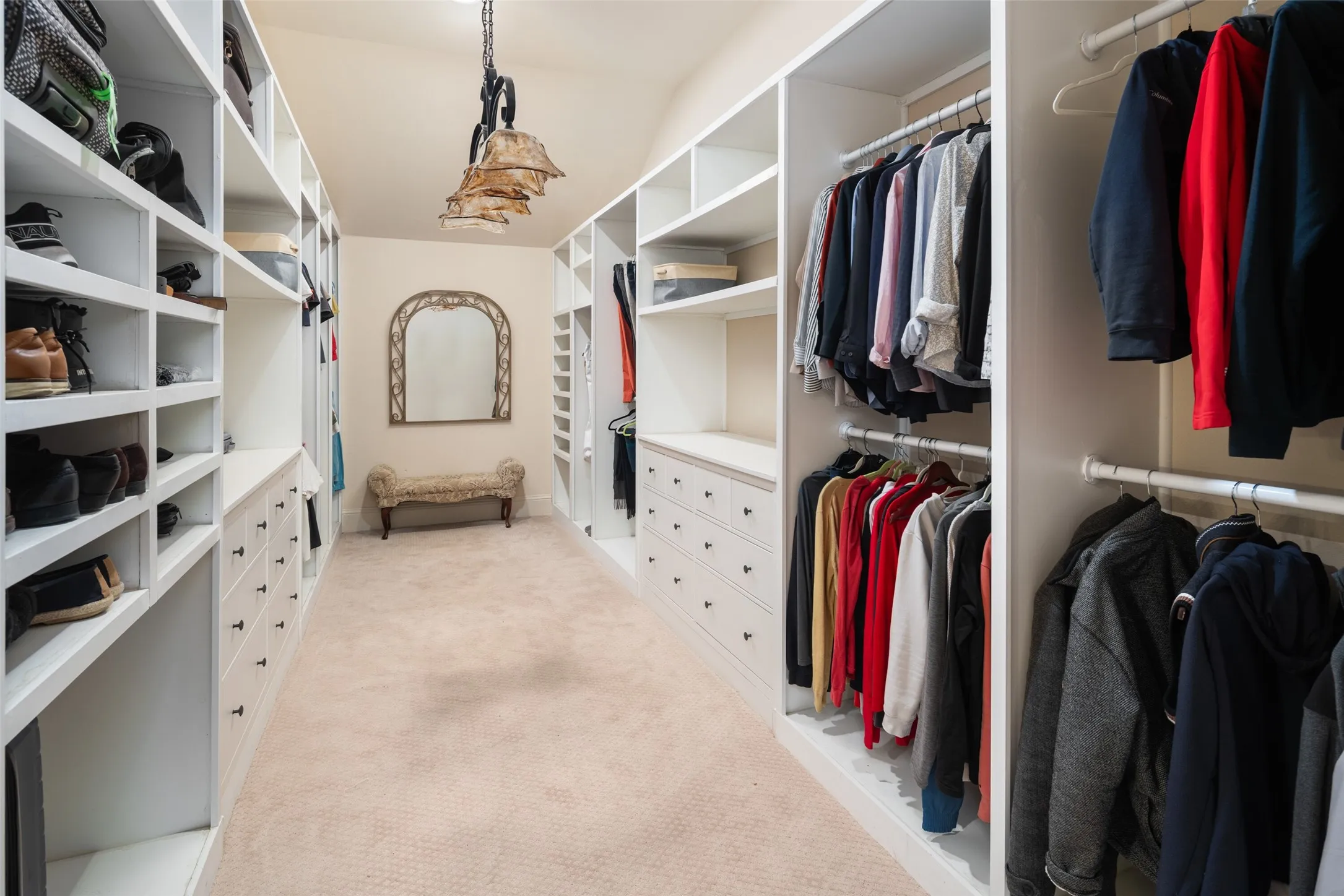 Spacious closet featuring light carpet and lofted ceiling