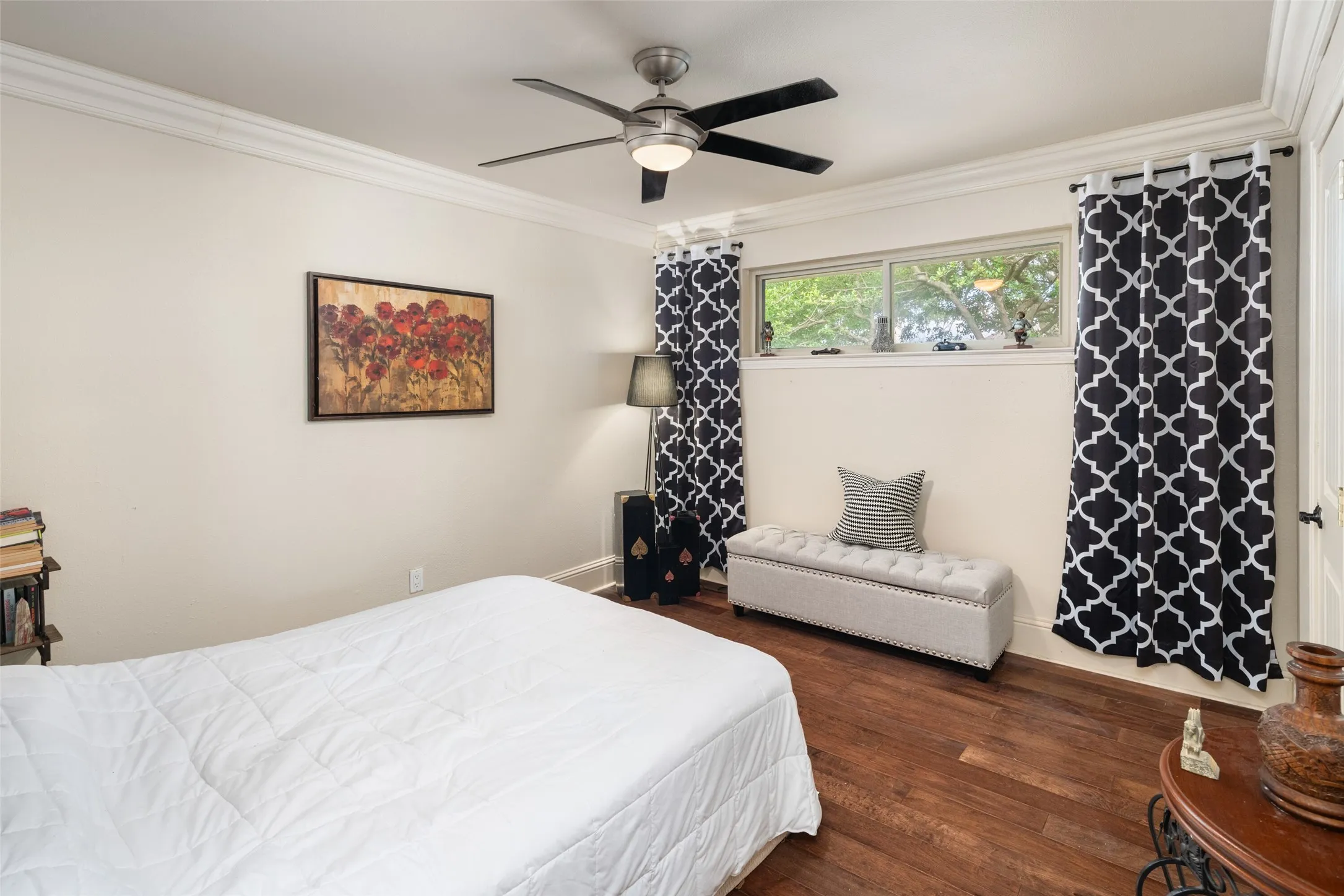 Bedroom featuring crown molding, wood finished floors, a ceiling fan, and baseboards