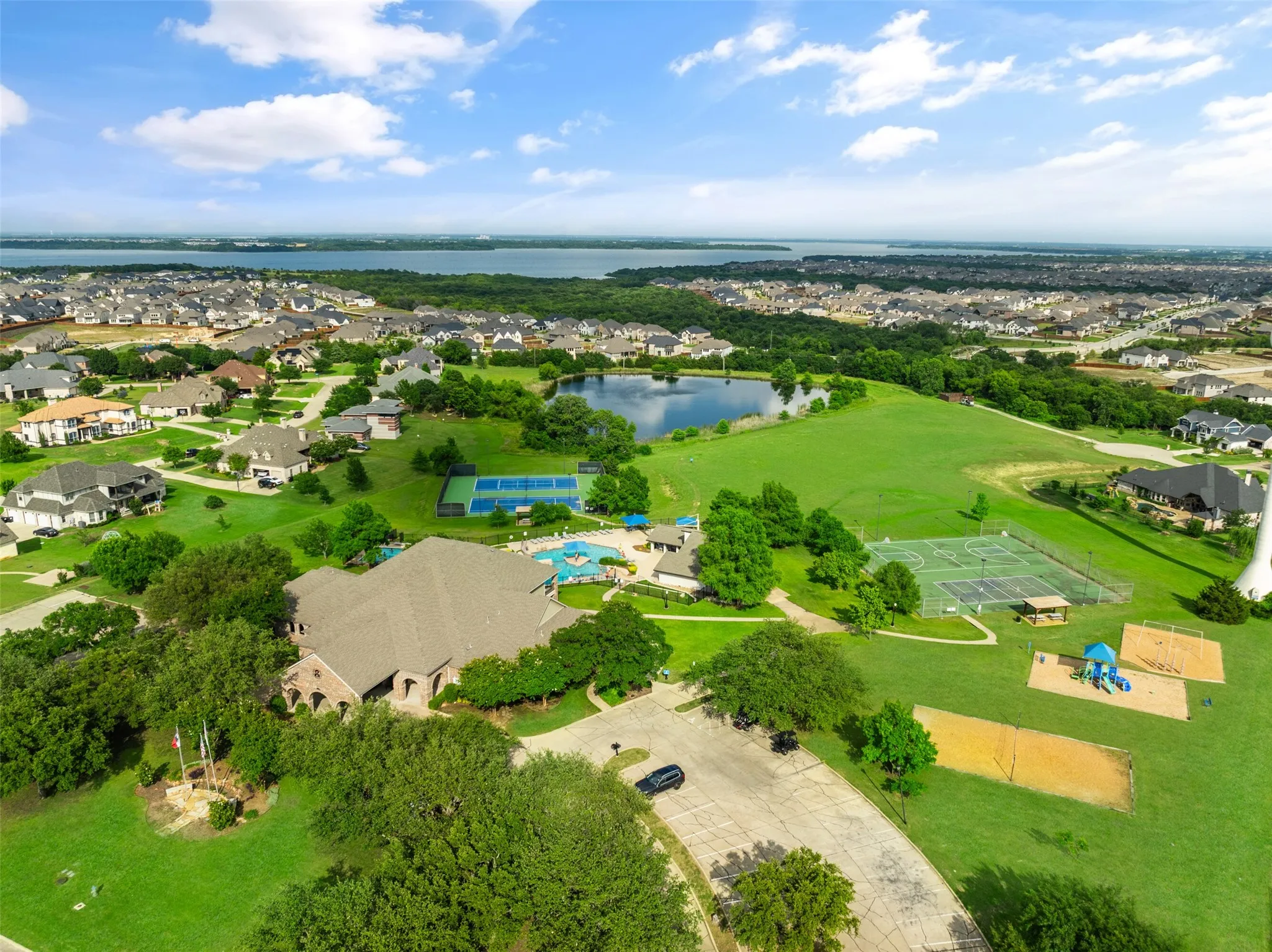 Aerial perspective of suburban area featuring a nearby body of water