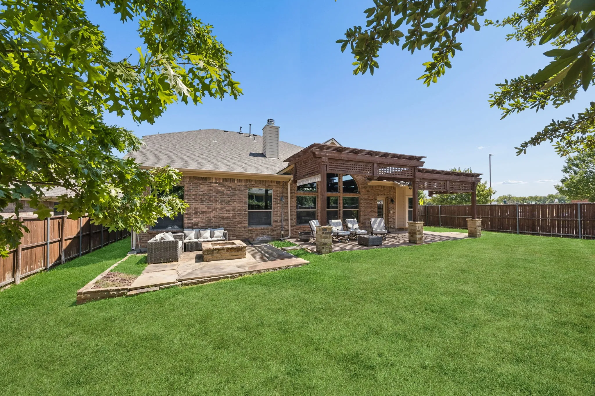 Fire pit and large grass backyard
