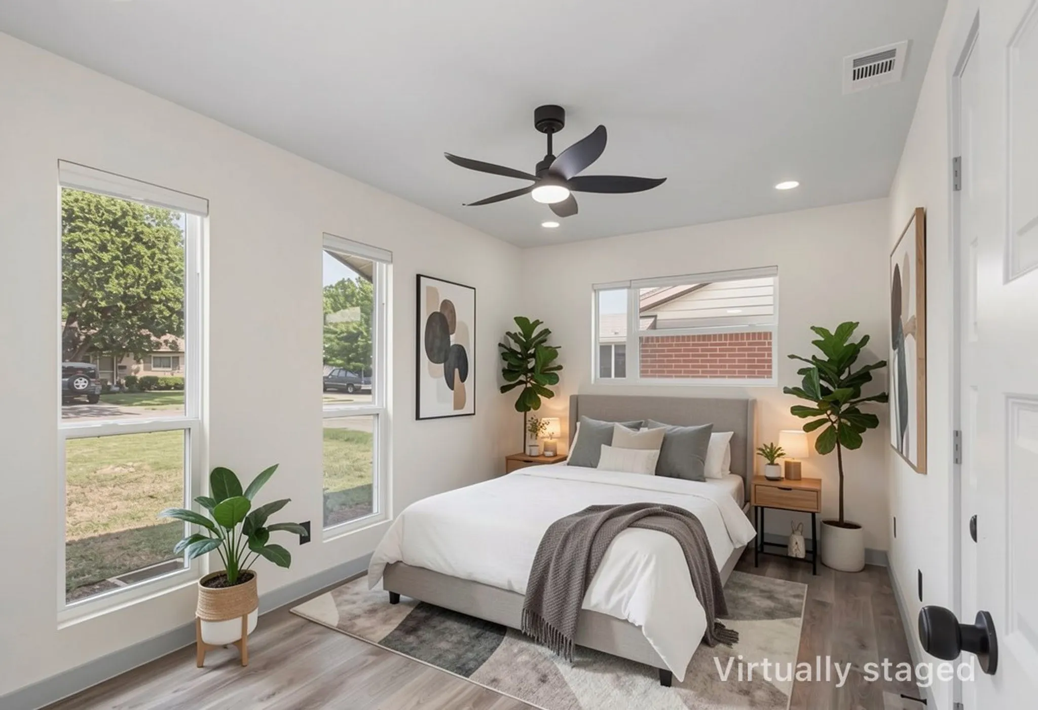 Bright bedroom featuring multiple windows, a ceiling fan with integrated lighting, recessed lighting, and wood-finish flooring