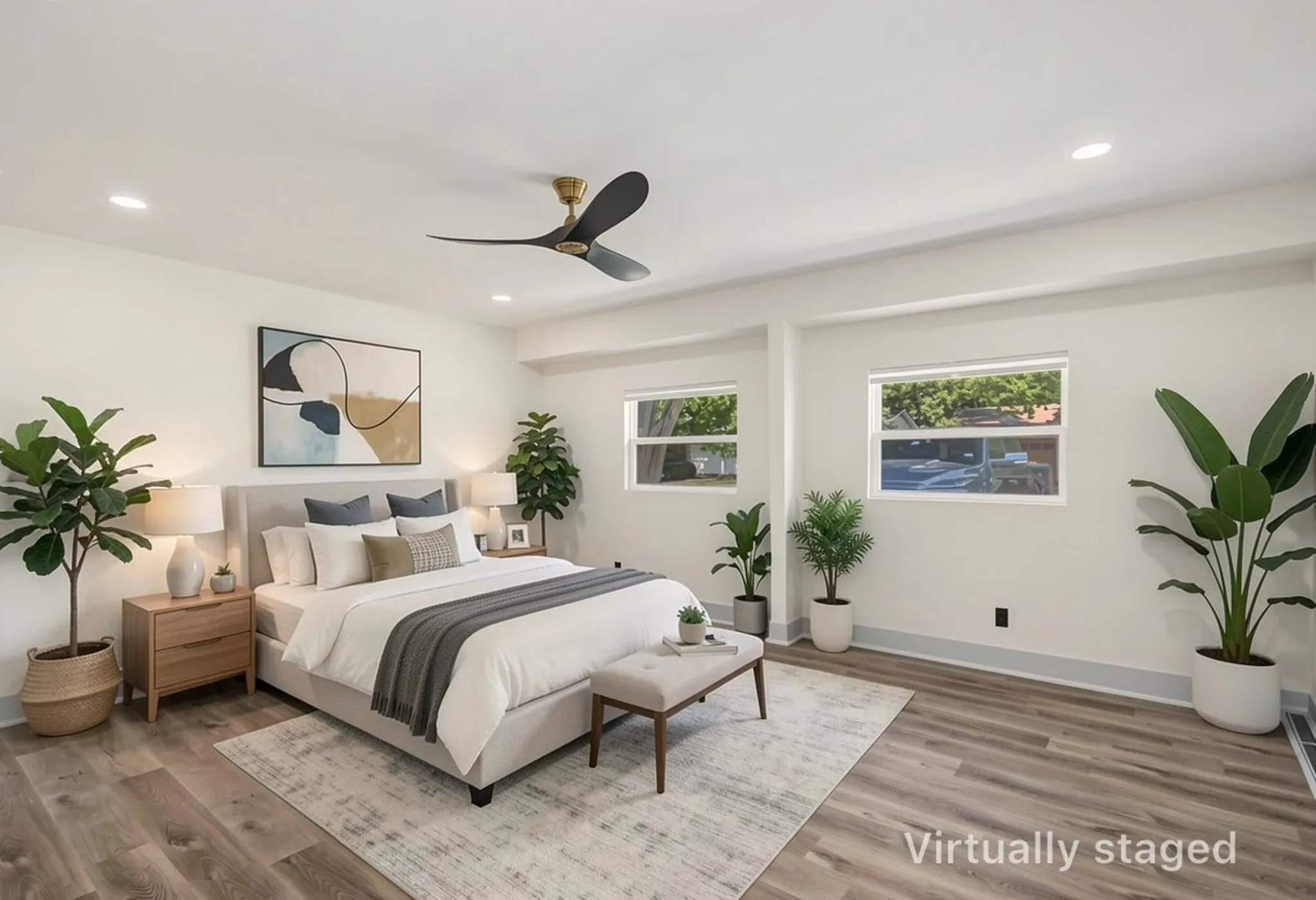 Spacious room featuring wood-finish flooring, recessed lighting, and a contemporary ceiling fan