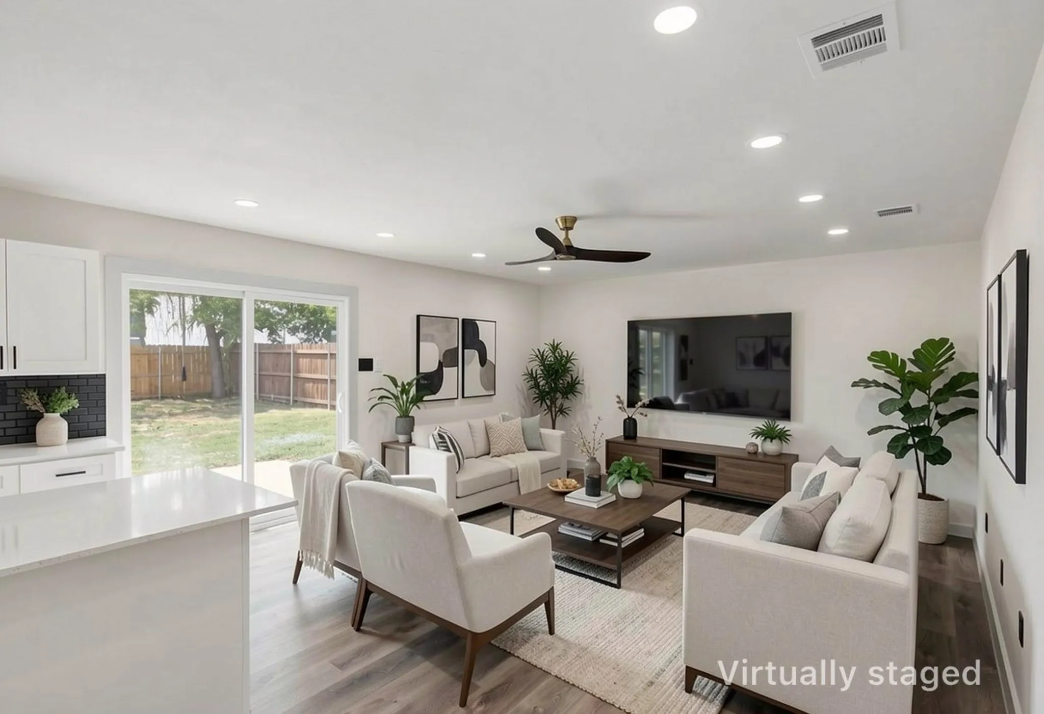 Open-concept living space featuring wood-finish flooring, recessed lighting, and a modern ceiling fan