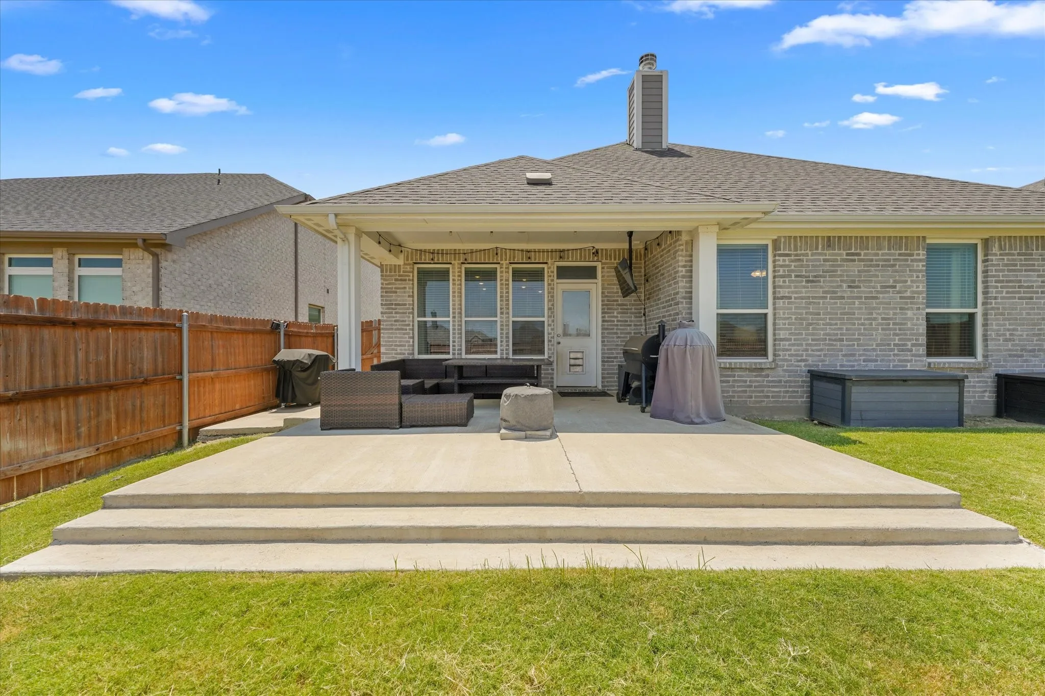 Expansive concrete patio with two-step entry
