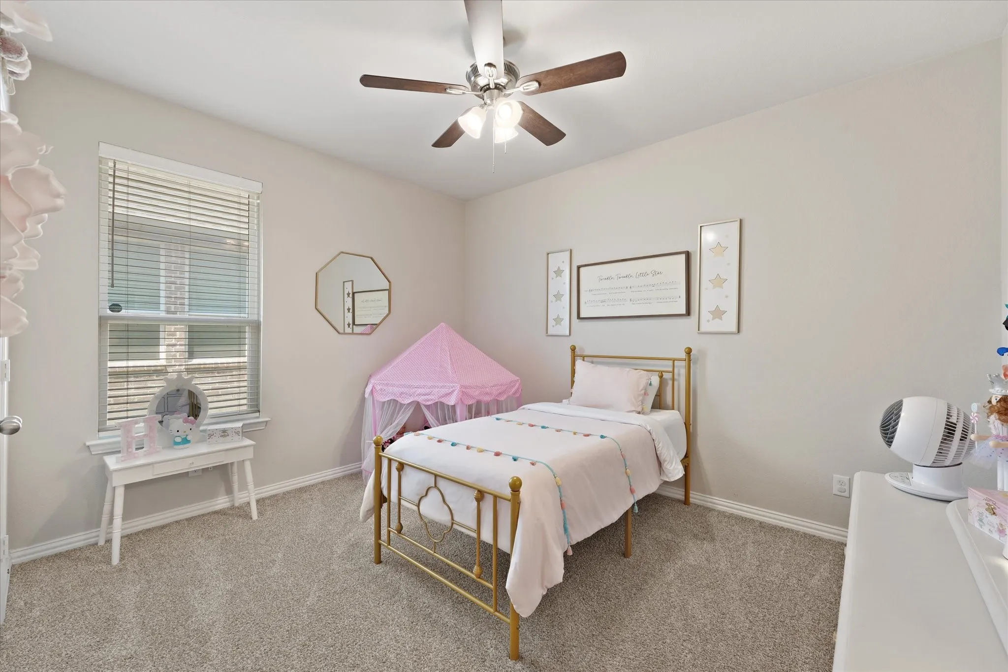 Carpeted bedroom featuring a ceiling fan with integrated lighting, a window with horizontal blinds, and neutral wall tones