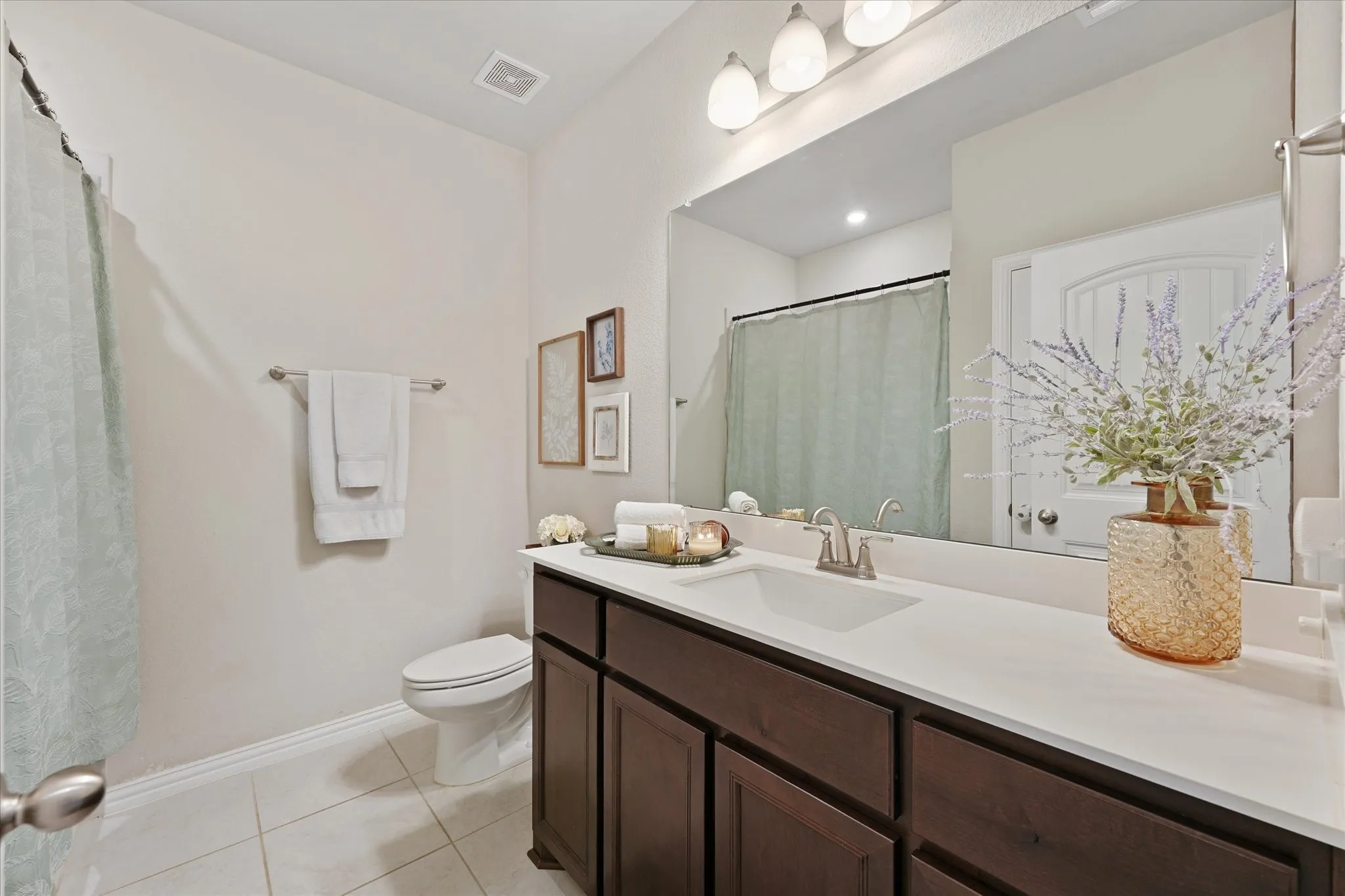 Bathroom vanity featuring a single basin, brushed nickel faucet, and a spacious countertop