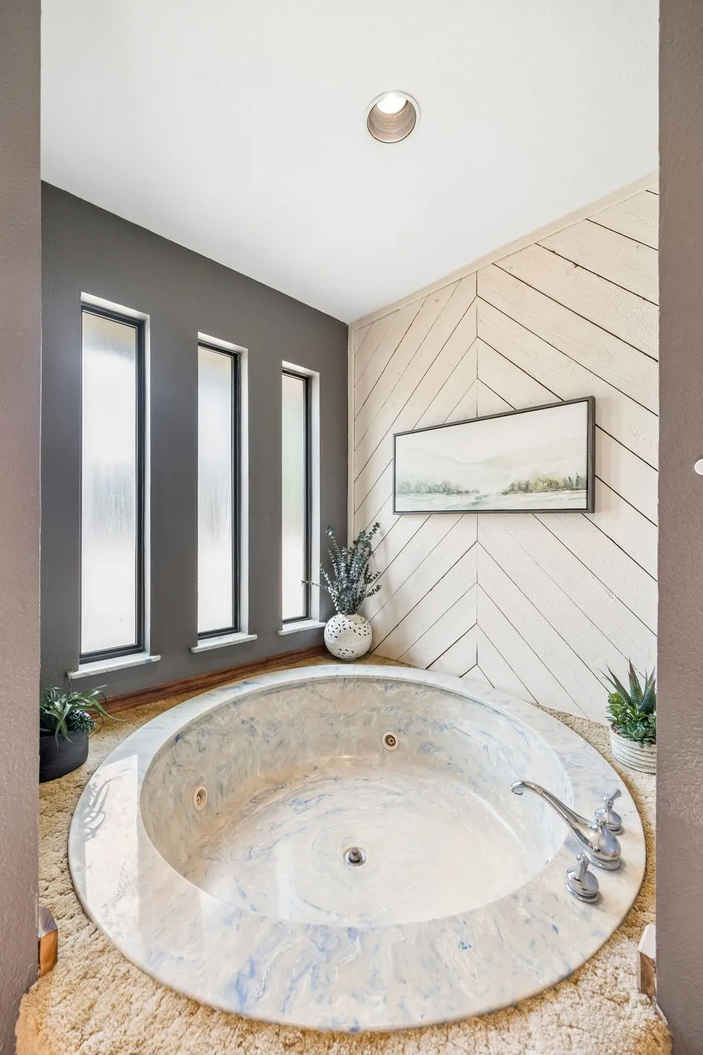 Deep-set jetted tub with a stone surround