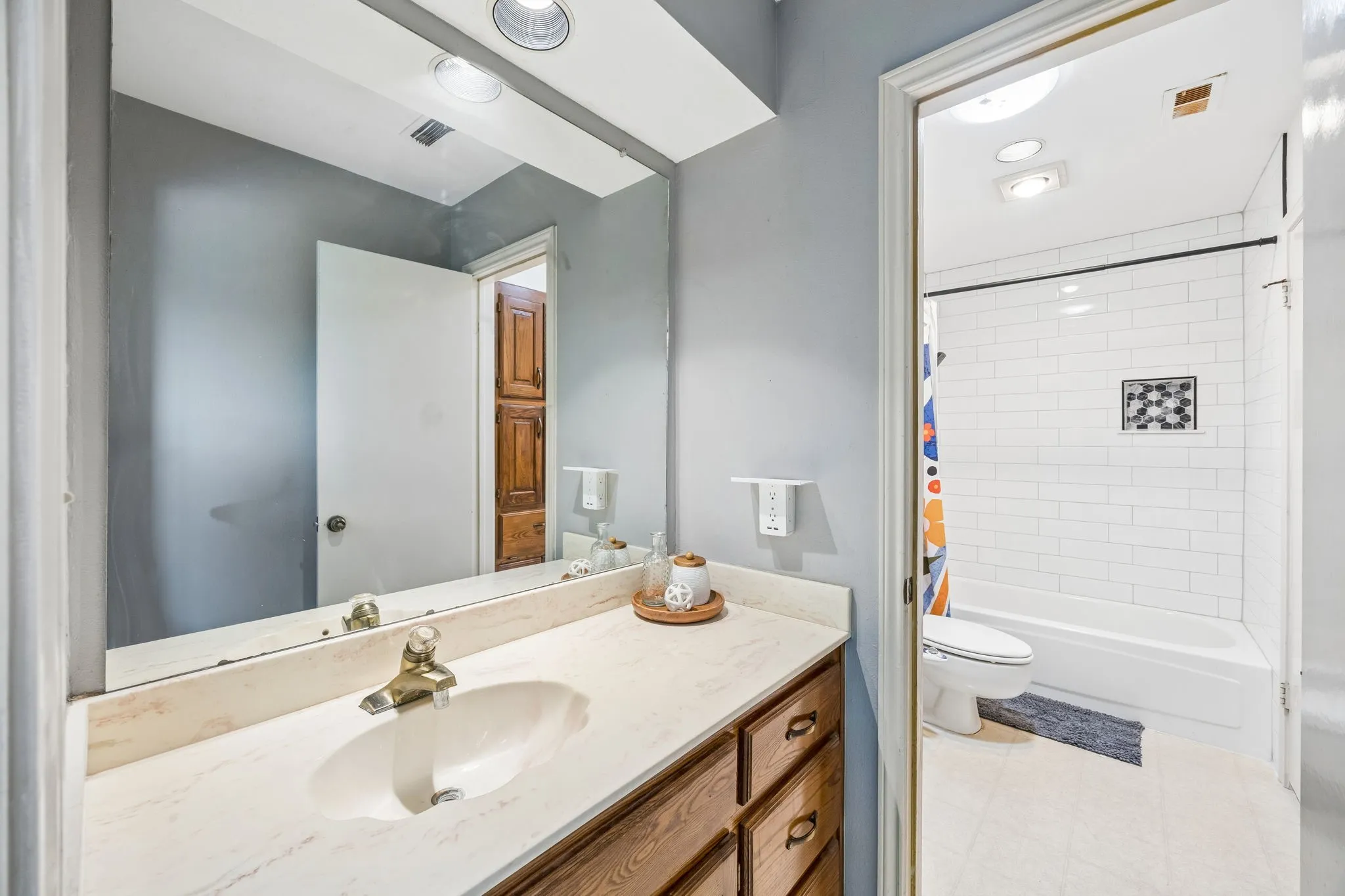 Bathroom featuring a vanity with a light-toned countertop and wood-finish cabinetry