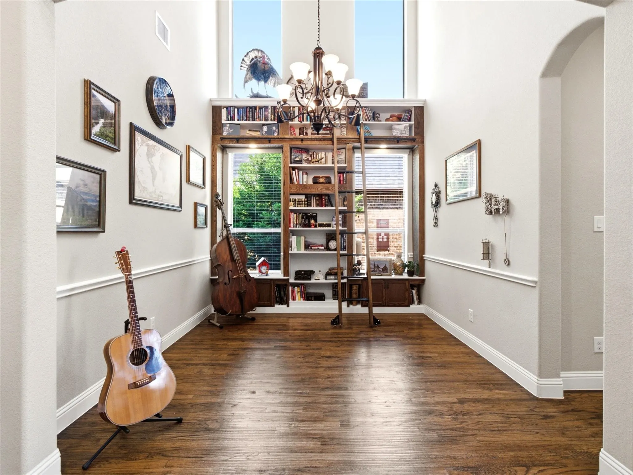 Library with rolling ladder featuring custon shelves.