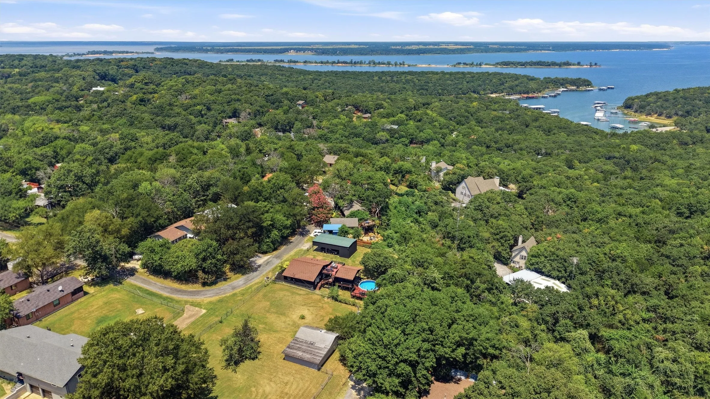 Expansive treed landscape with water frontage and multiple watercraft
