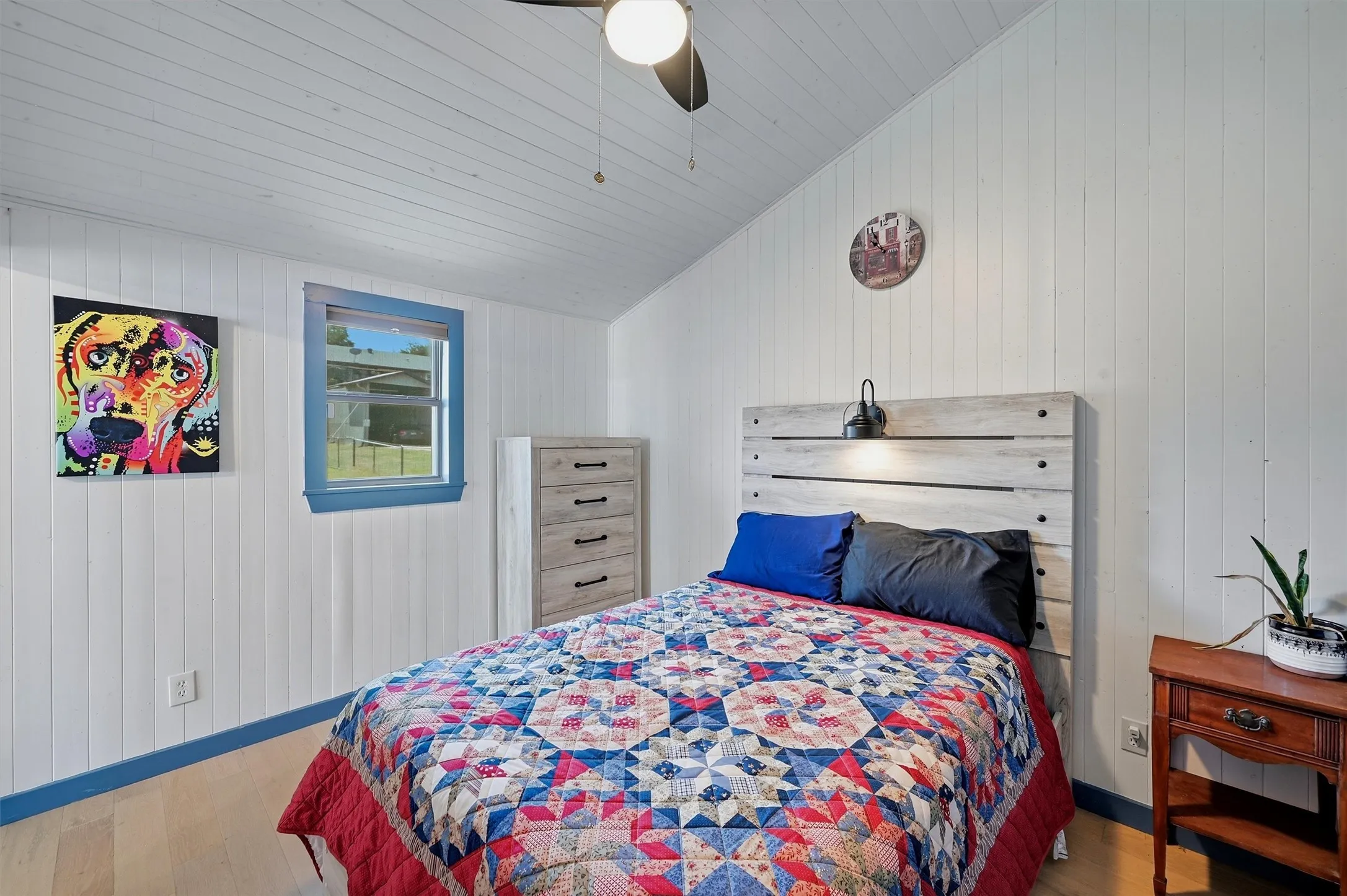 White shiplap walls and ceiling with wood-finish flooring