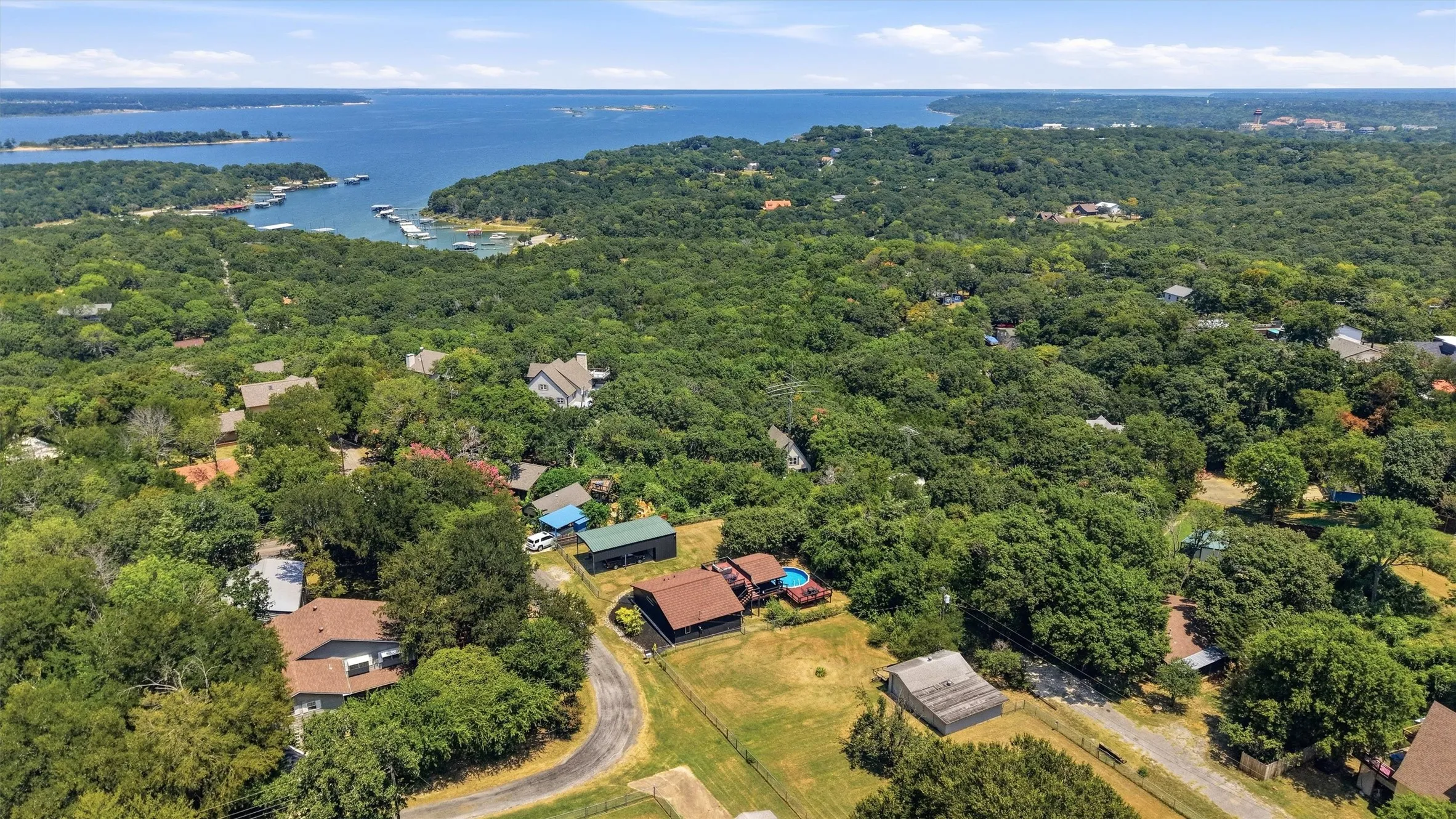 Aerial perspective showcasing expansive treed surroundings and substantial water body