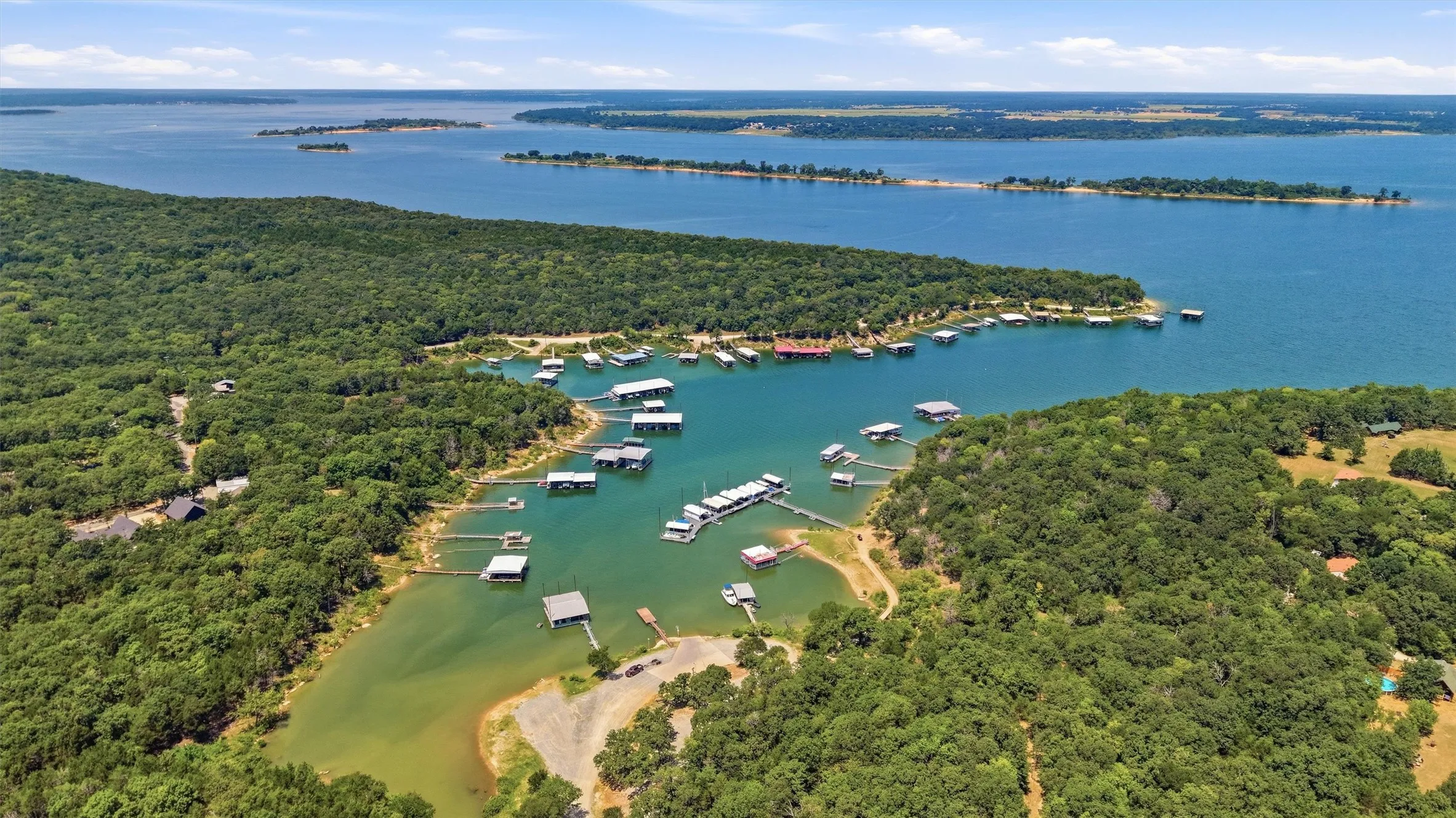 Expansive waterfront with multiple private docks and lush, mature trees