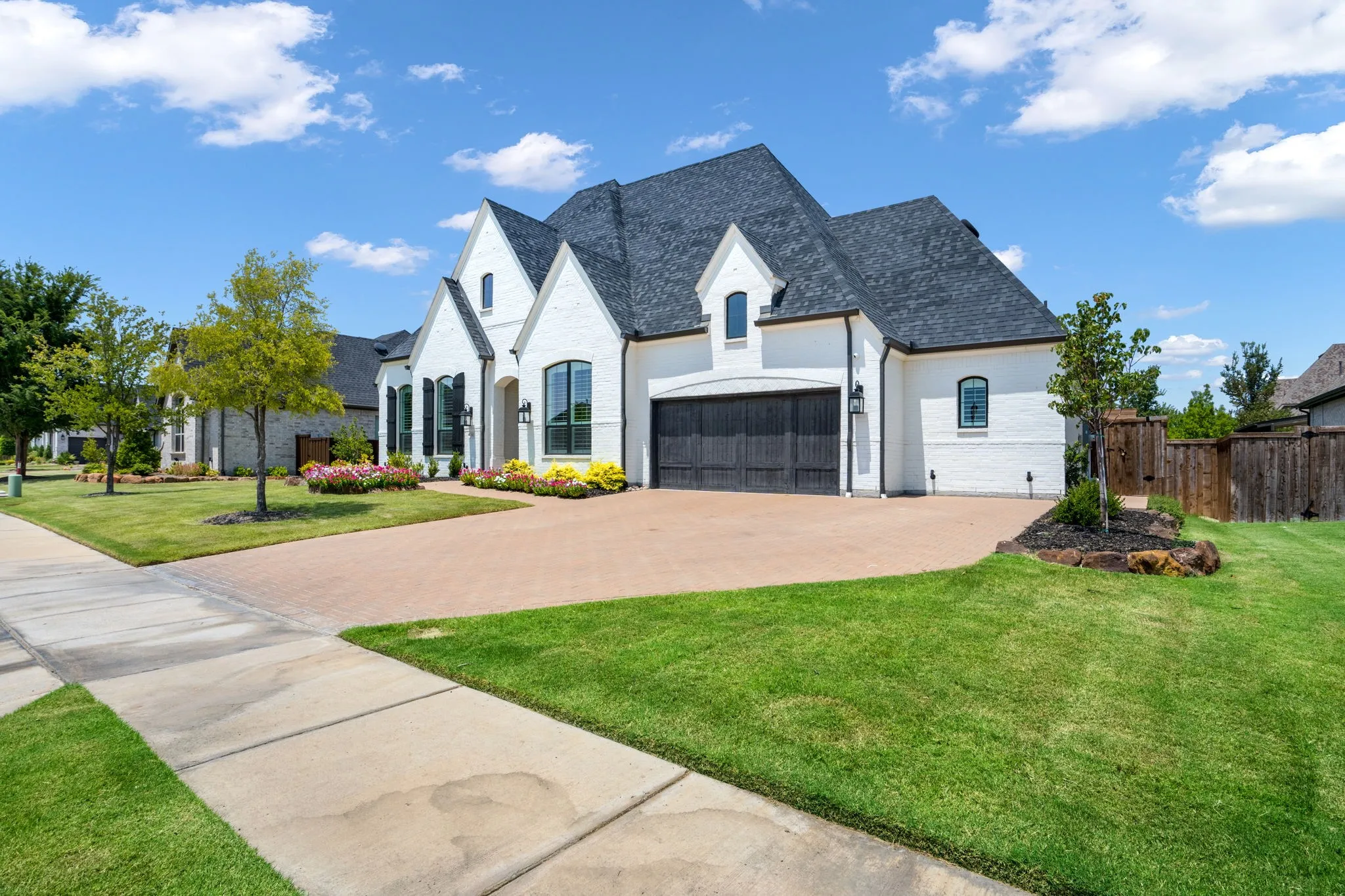 White brick exterior with dark shingle roofing