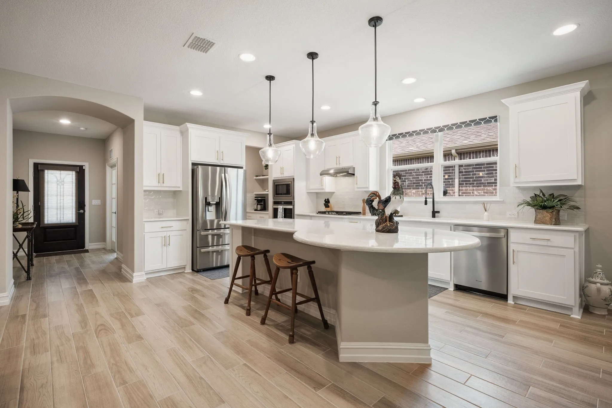 Gourmet kitchen with quartz countertops and gold hardware.