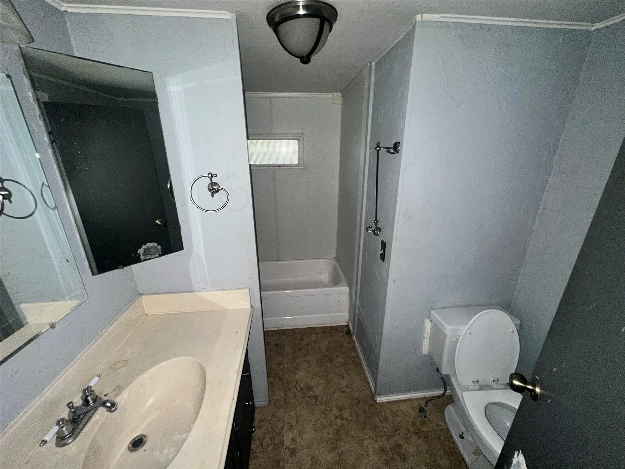 Bathroom featuring a bath, toilet, and vanity