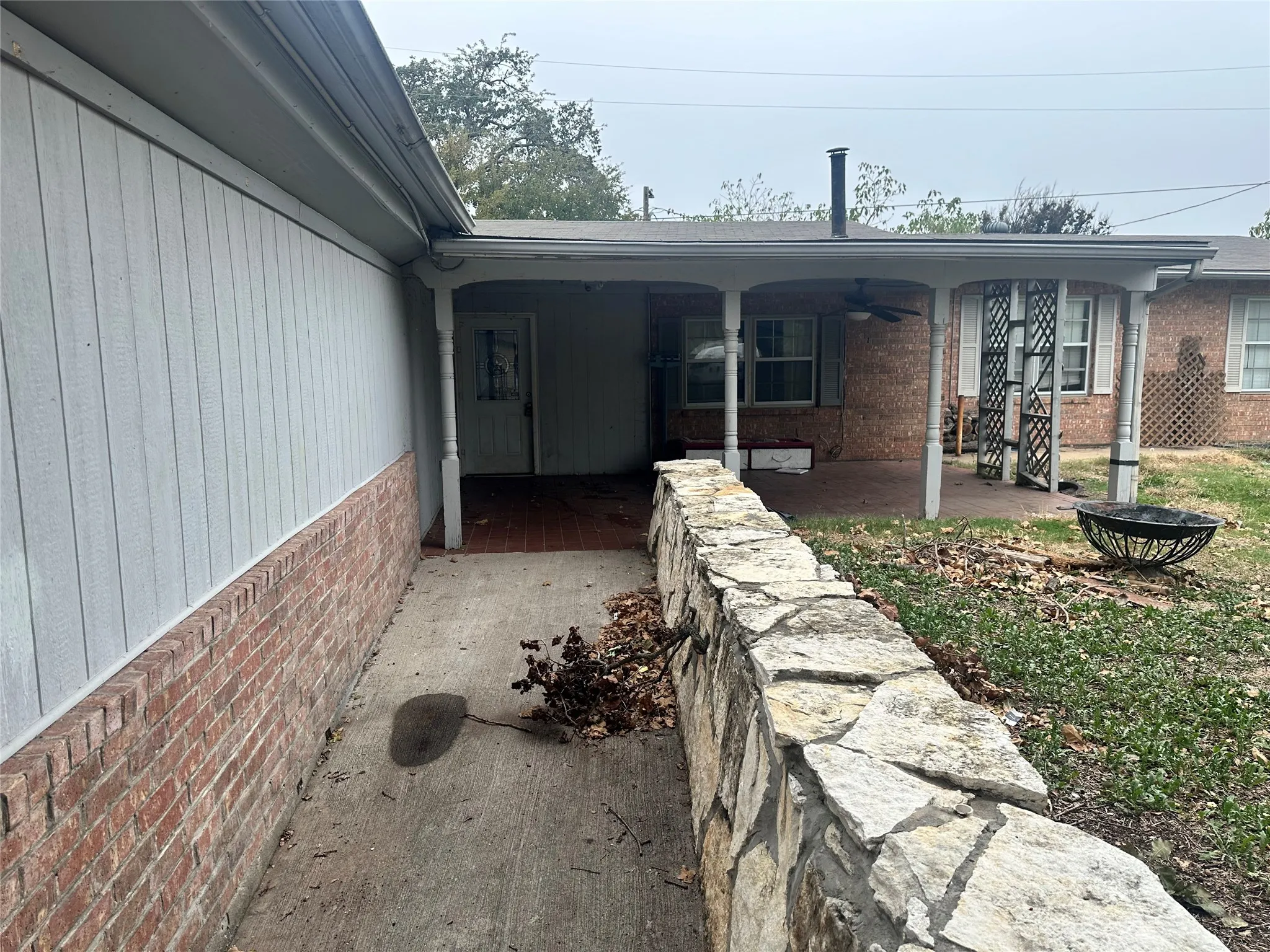 View of exterior entry with a patio area and ceiling fan