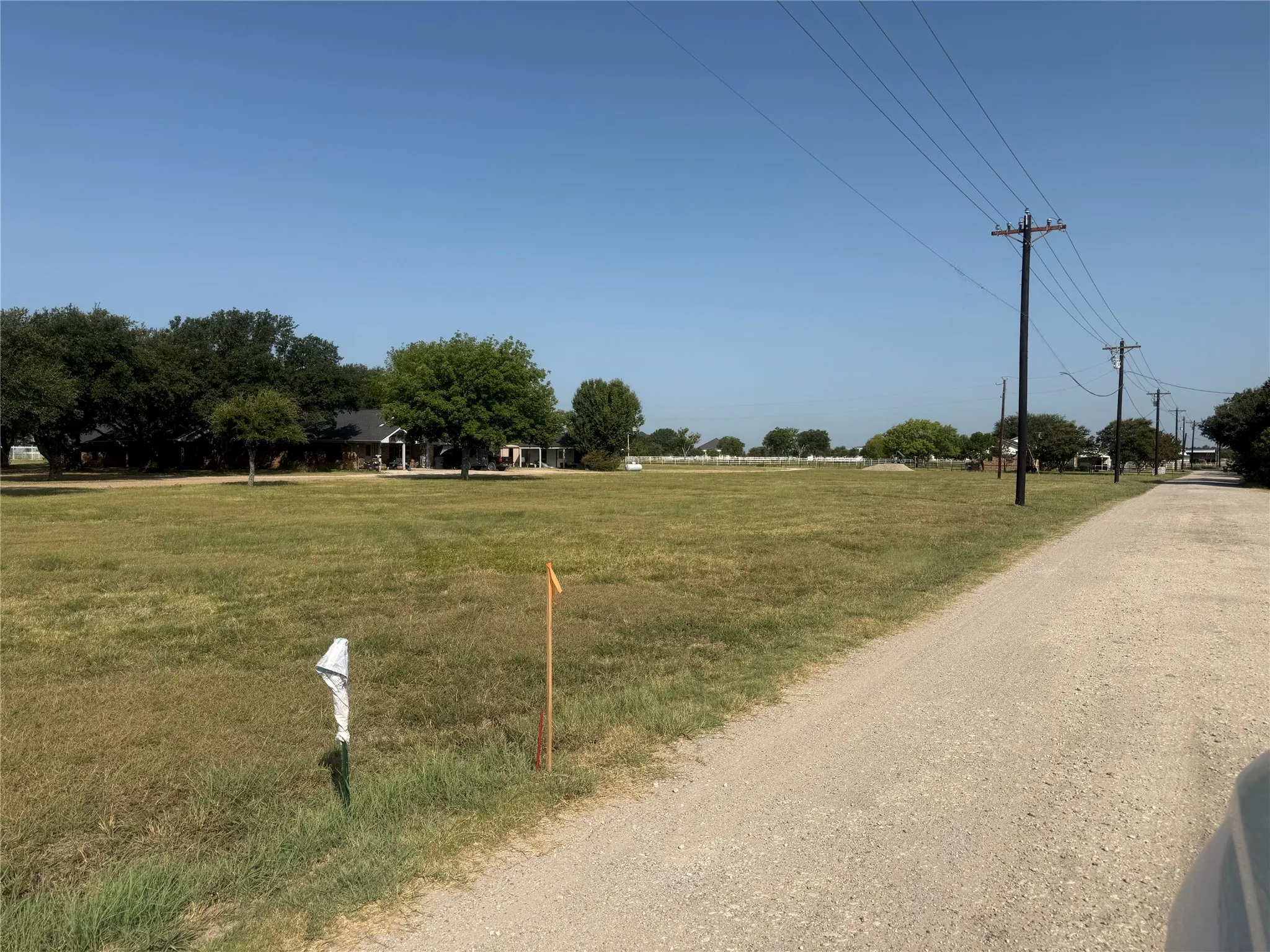 Expansive grass lot, a gravel road