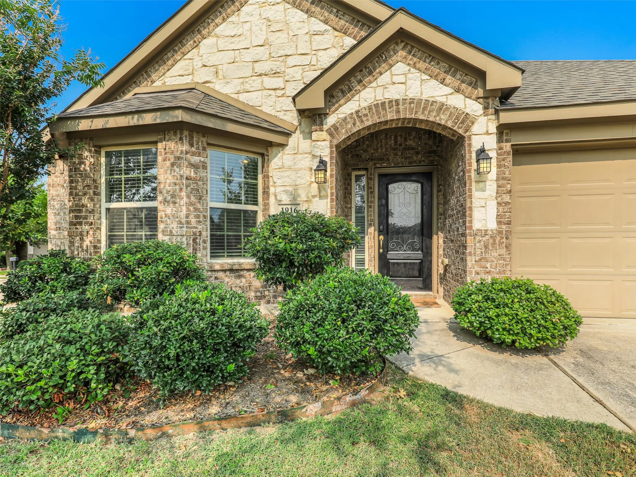 Stone and brick facade with an arched entry