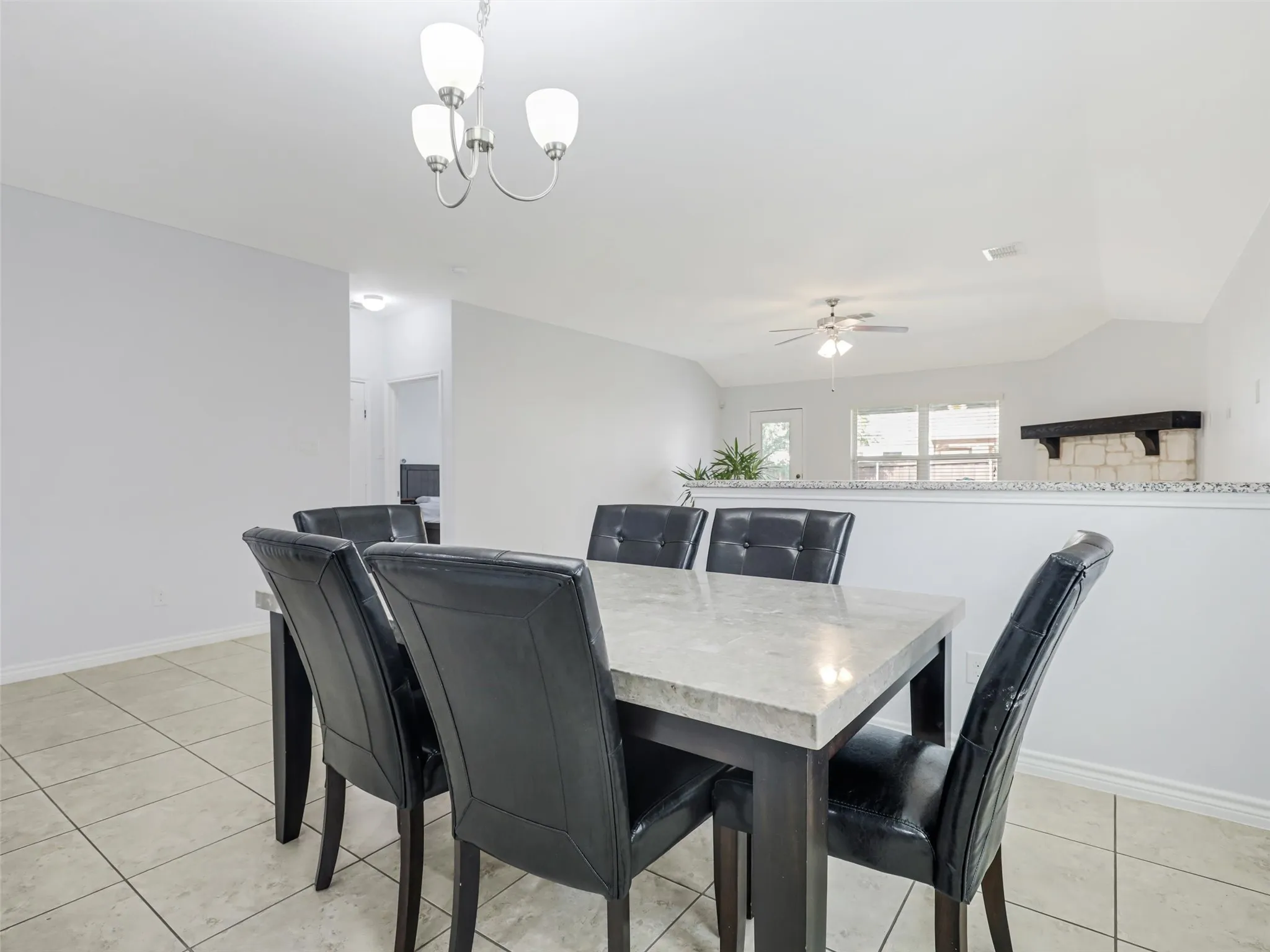 Dining area featuring tile flooring and a modern chandelier