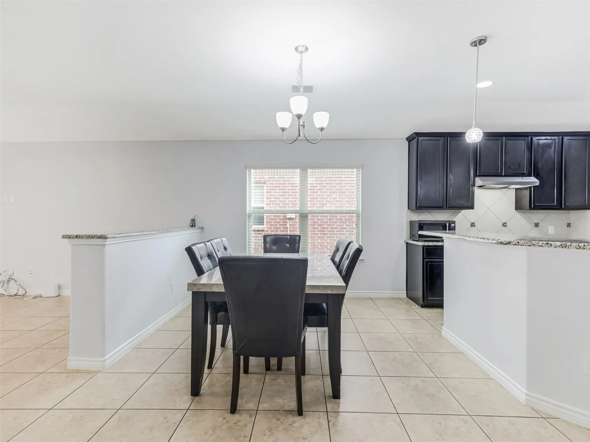 Open-concept living space featuring neutral tile flooring throughout