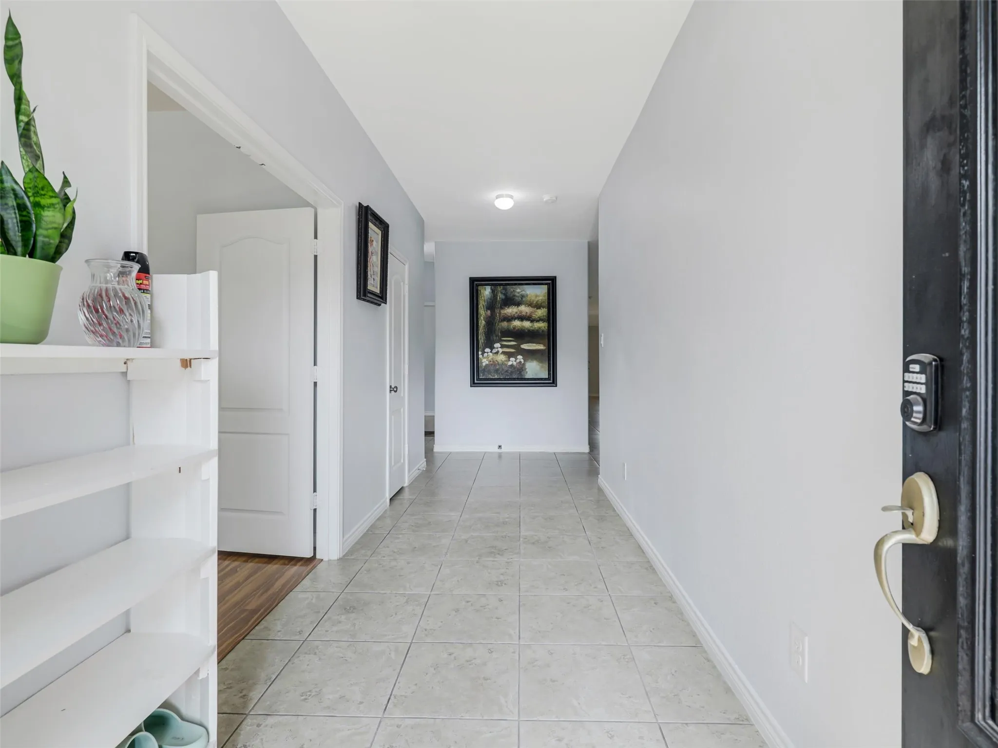Entryway featuring ceramic tile flooring, light neutral wall tones, and a recessed ceiling light