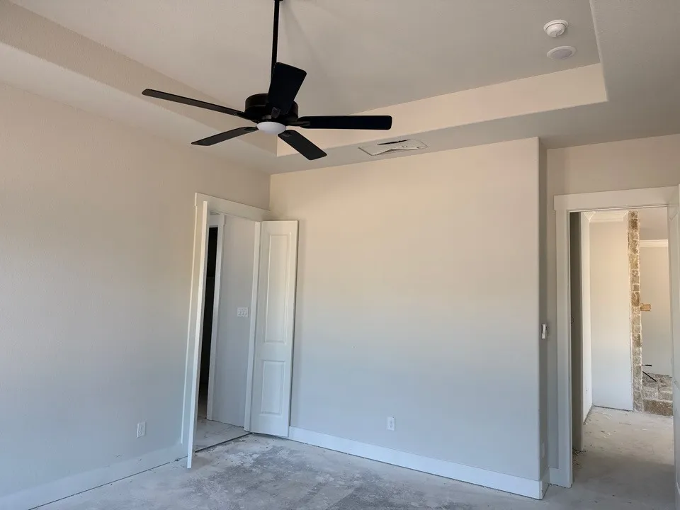 Tray ceiling featuring recessed lighting and a black ceiling fan