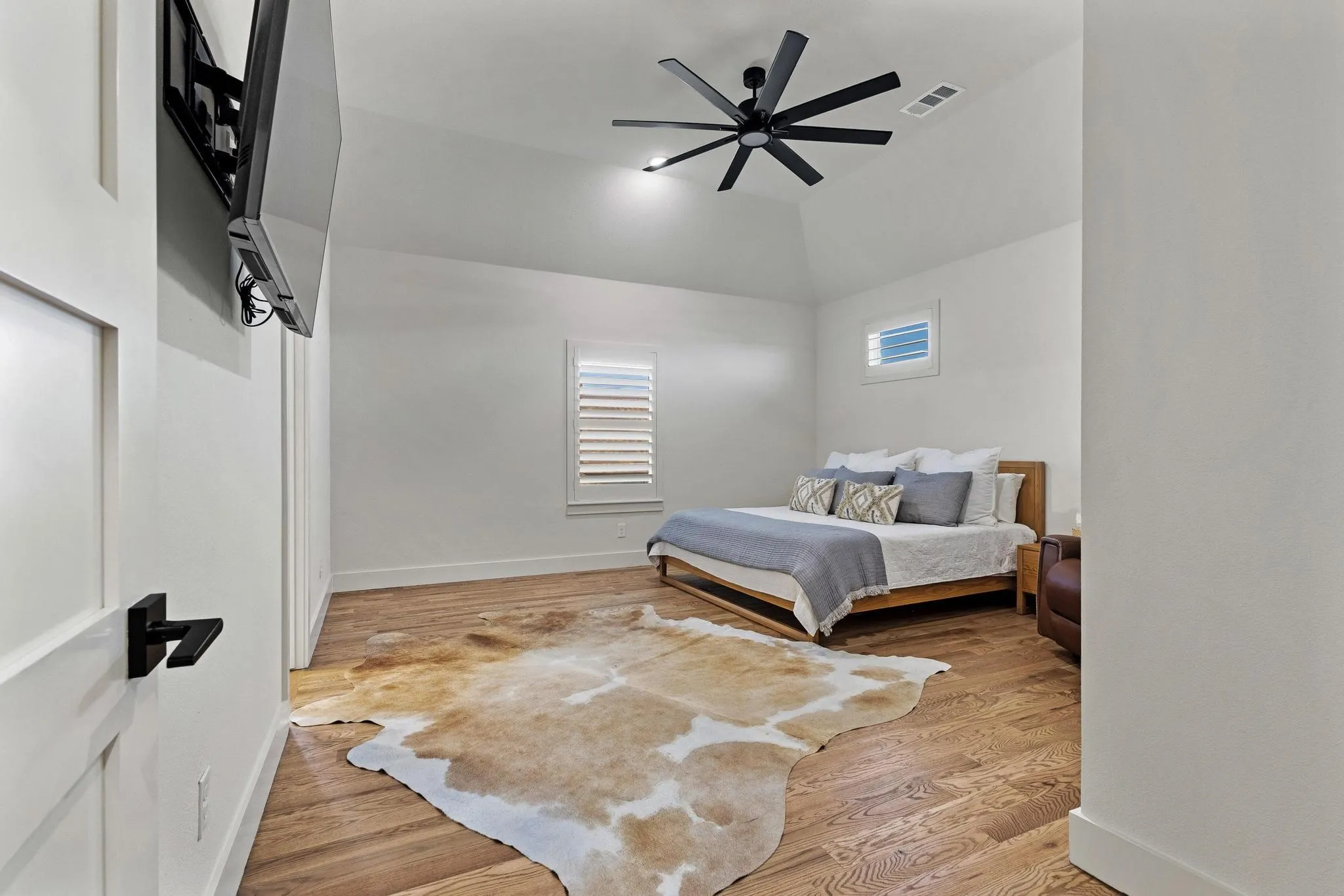 Vaulted ceiling with a black ceiling fan