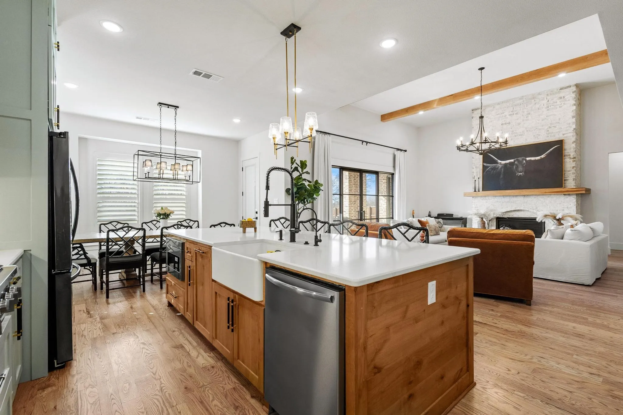 Open-concept kitchen and living area featuring wood-finish flooring