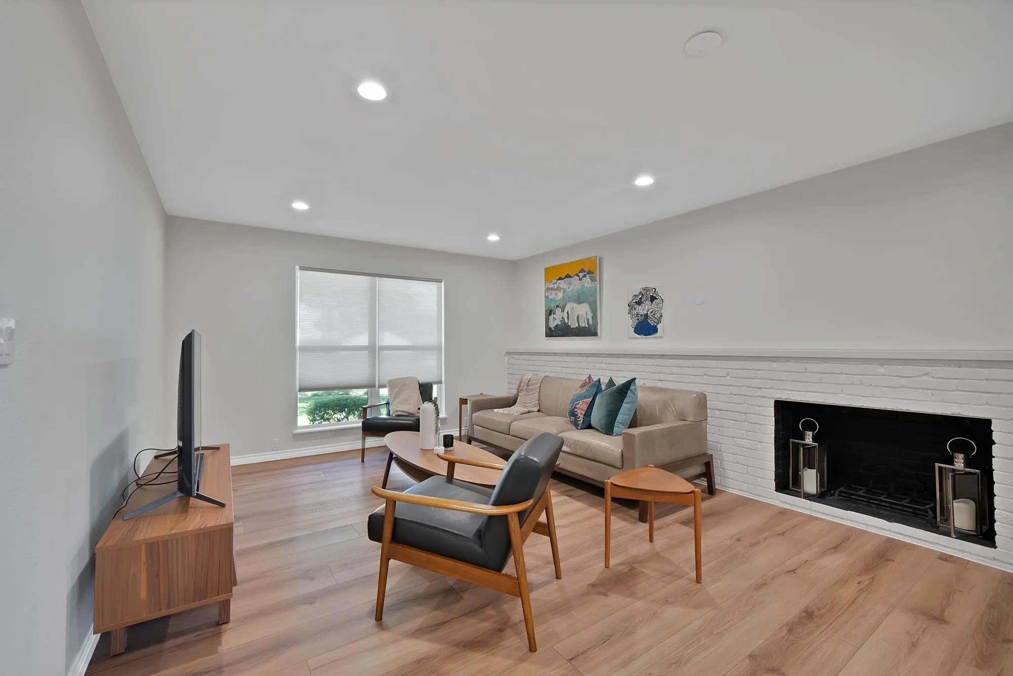Recessed lighting illuminates the wood-finish flooring