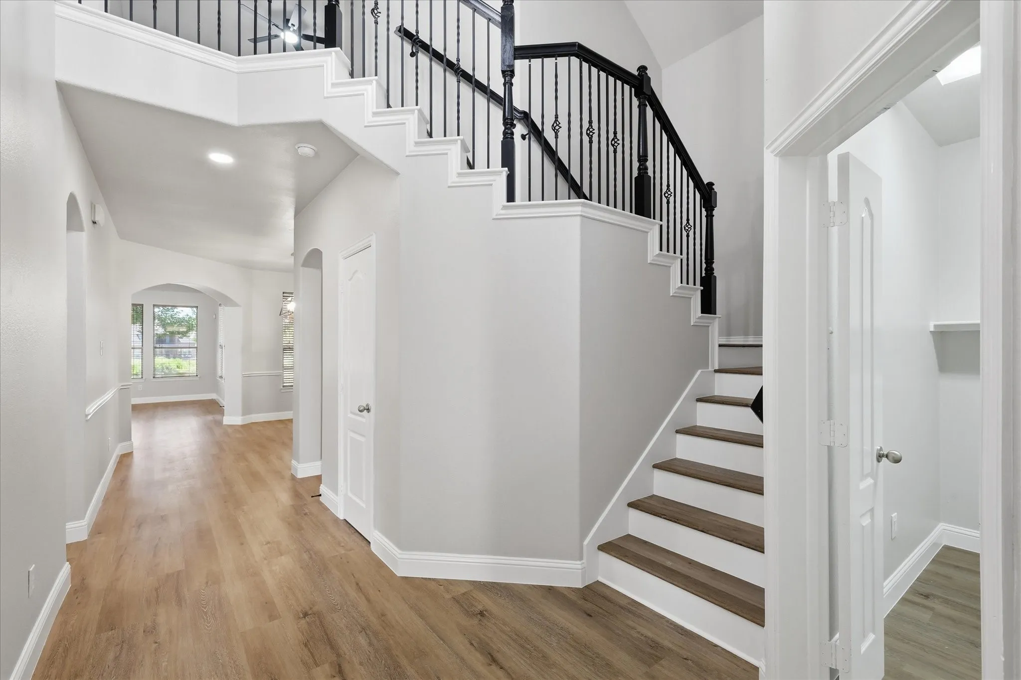 Upon entering, you are greeted with 2026 lvp flooring, recessed lighting, and arched doorways.