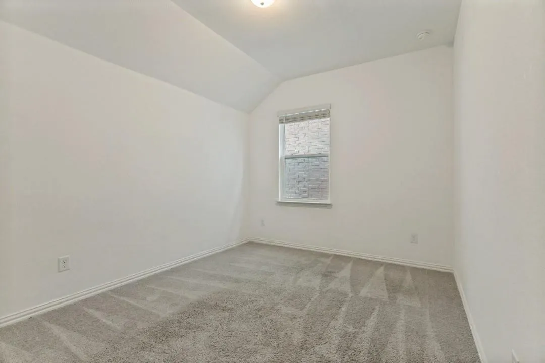 Bright secondary bedroom featuring neutral wall finishes, recessed ceiling lighting, and plush carpeting throughout