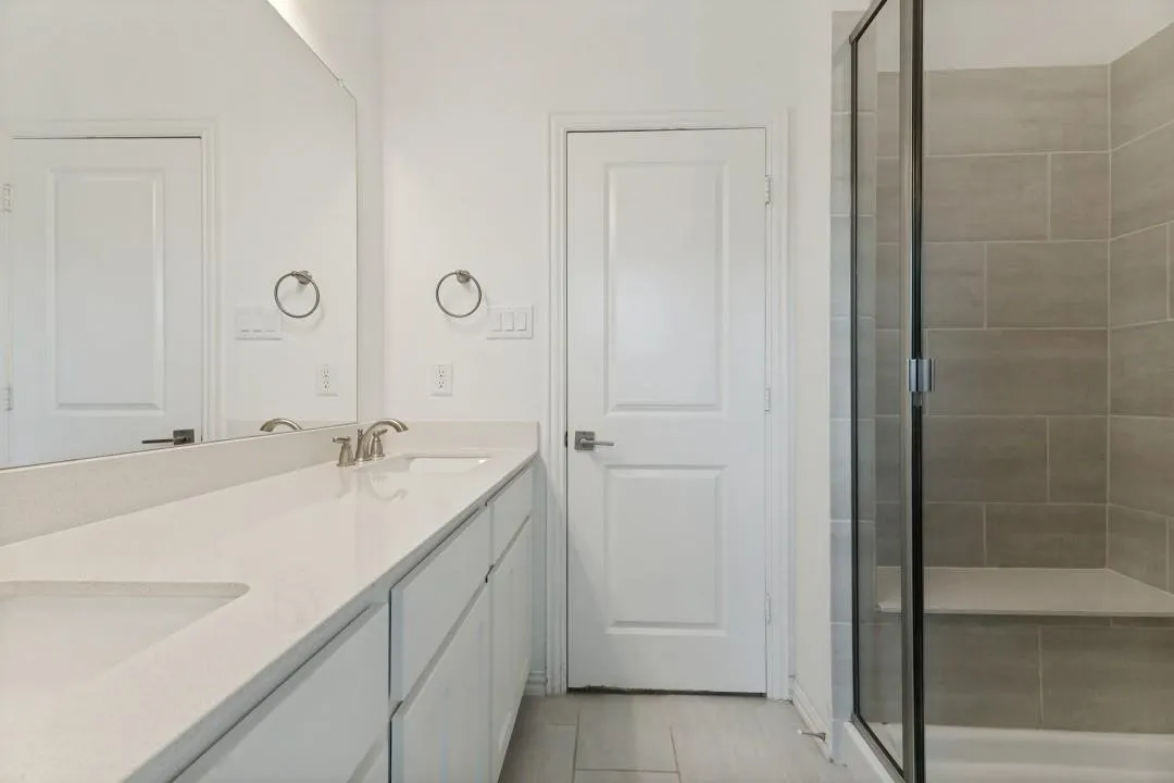 Double vanity with integrated sinks and a light-toned countertop