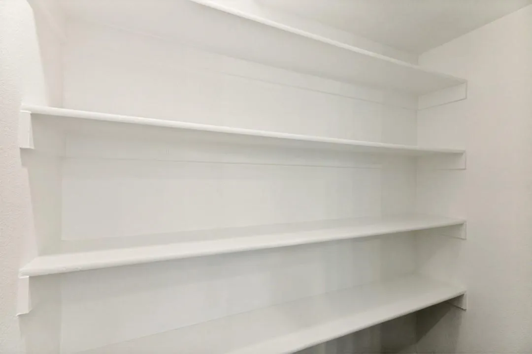 Built-in wall-mounted shelving providing vertical storage