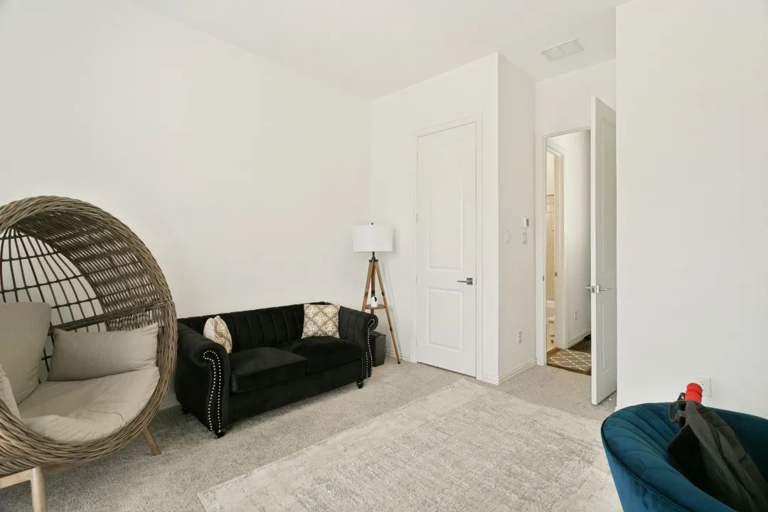 Bright interior space with carpeted flooring and white walls
