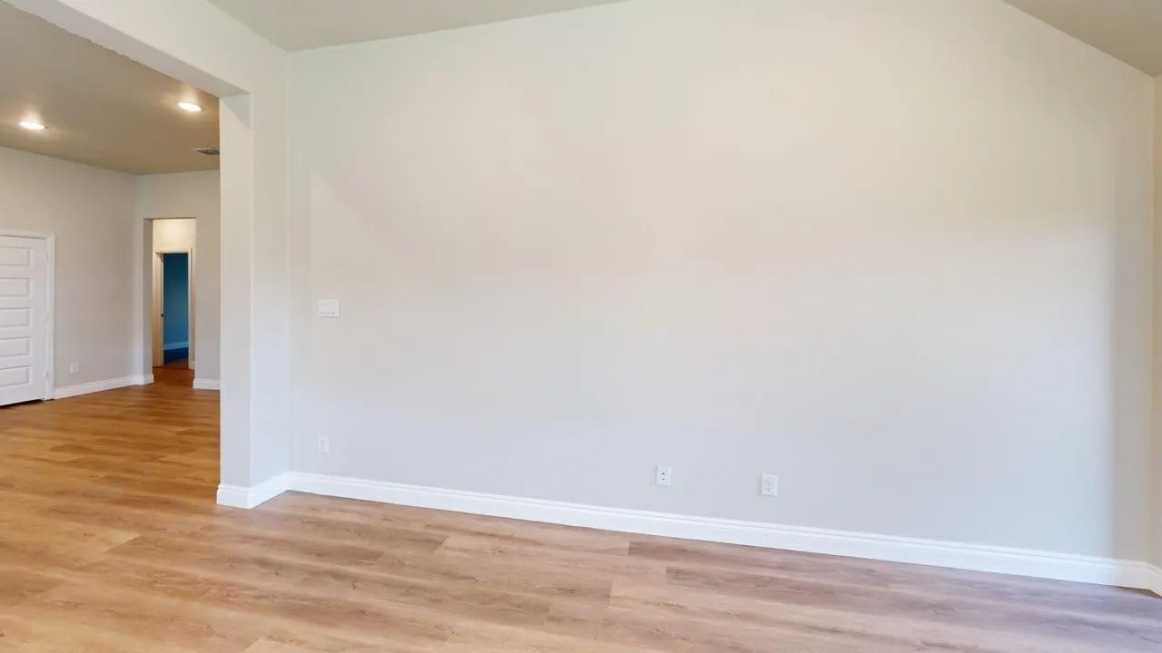 Vaulted ceiling, recessed lighting, wood-finish flooring, white trim, paneled interior door
