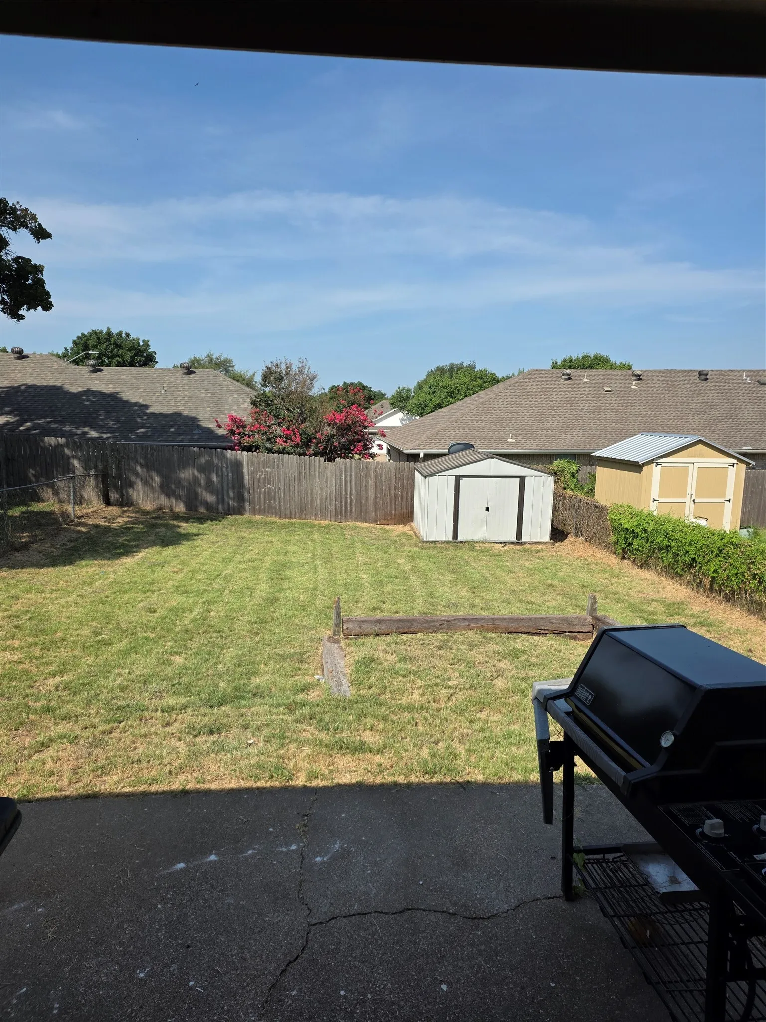 Large fenced yard with storage shed