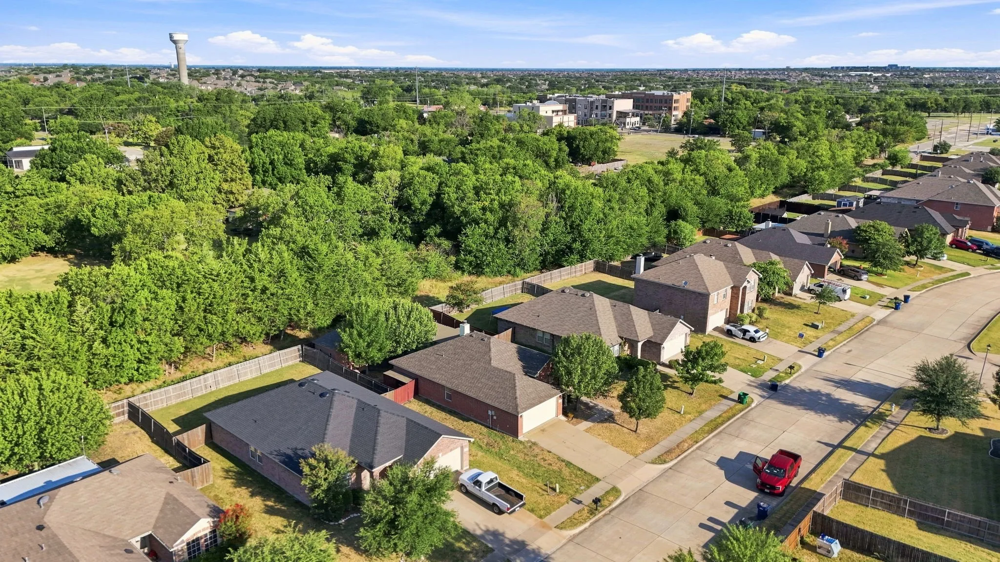 Residential street with single-family homes and mature trees