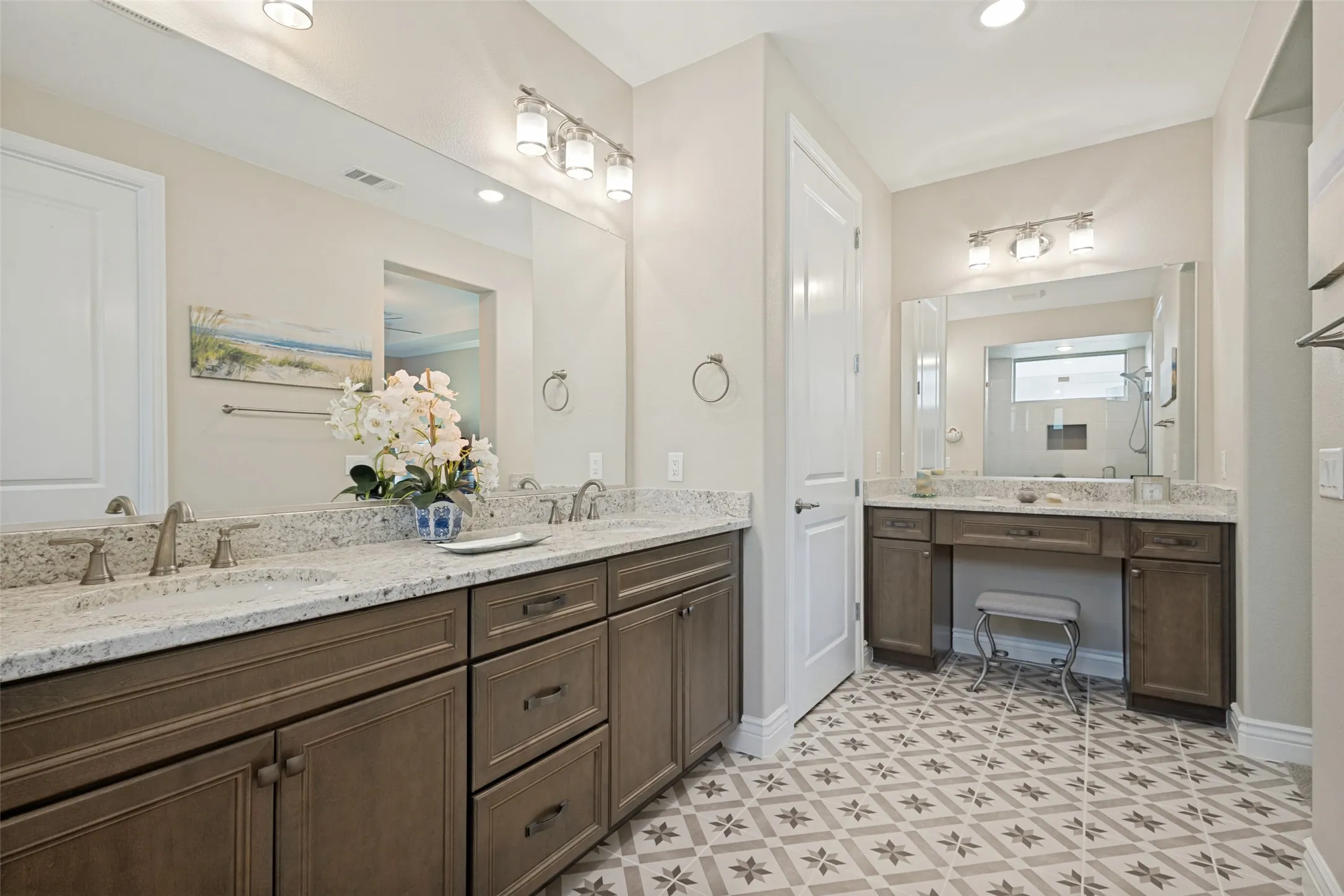 A ON TREND CERAMIC TILE FLOOR IN BEAUTIFUL NEUTRAL DESIGN IS A SHOW STOPPER. DUAL SINK VANITY WITH GRANITE COUNTERS AND A SEPERATE VANITY TOO. UPGRADED LIGHTING AND HARDWARE FINISH THE SPACE.