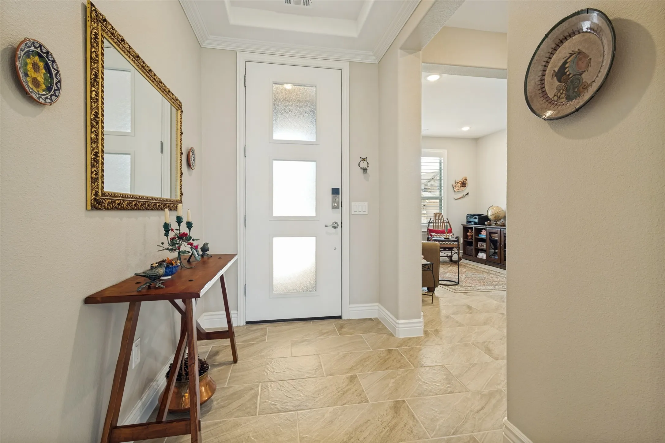 LARGE PLANK CERAMIC TILE IN NEUTRAL SHADES OF BEIGE AND TAUPE IS FEATURED IN MOST ROOMS. A PEEK INTO THE DEN/STUDY.