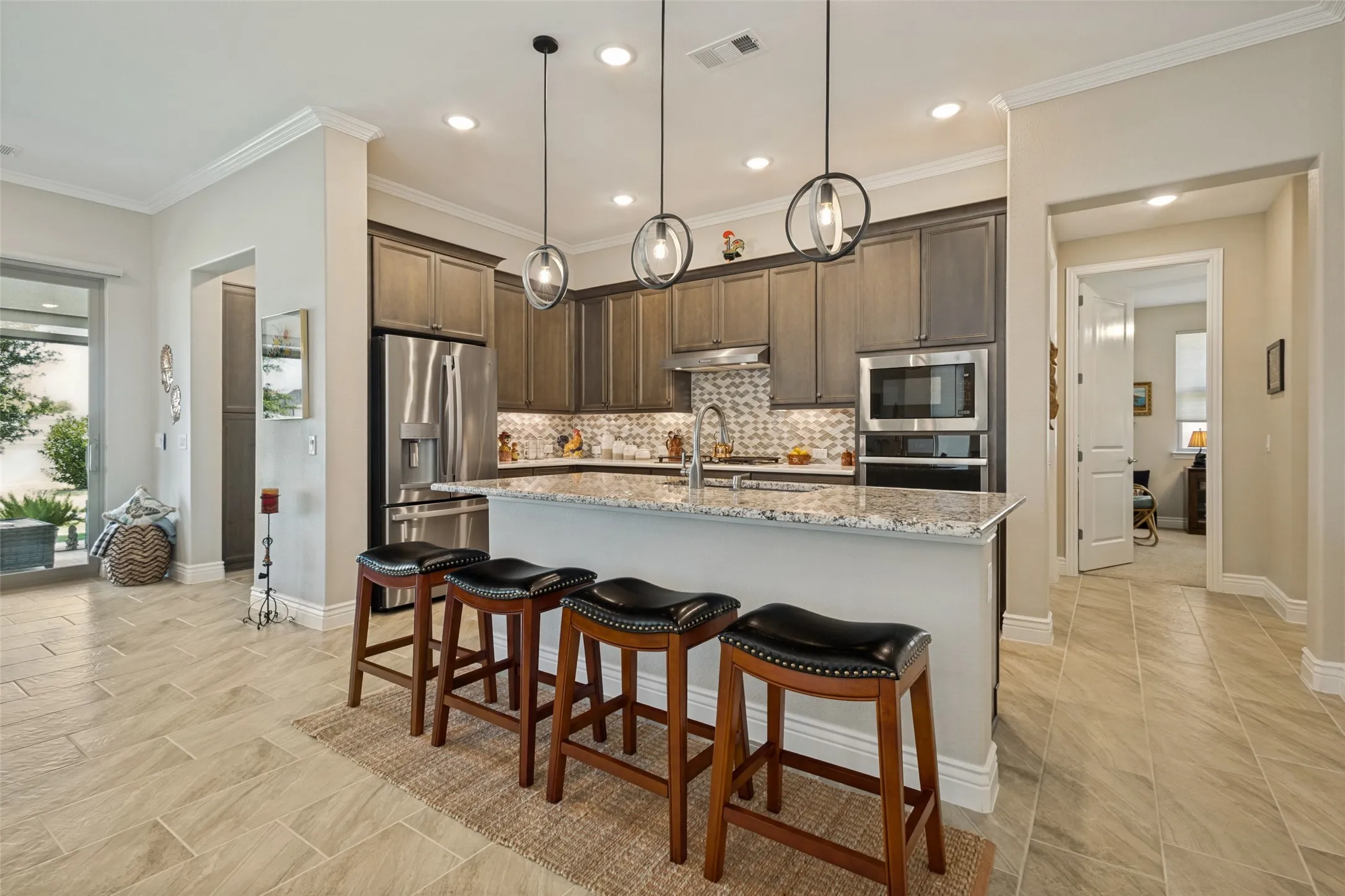 SPLIT BEDROOM FLOOR PLAN IS IDEAL. TO THE LEFT IS PRIMARY BEDROOM AND IN THE BACKGROUND IS THE ENTRY TO THE GUEST SUITE.