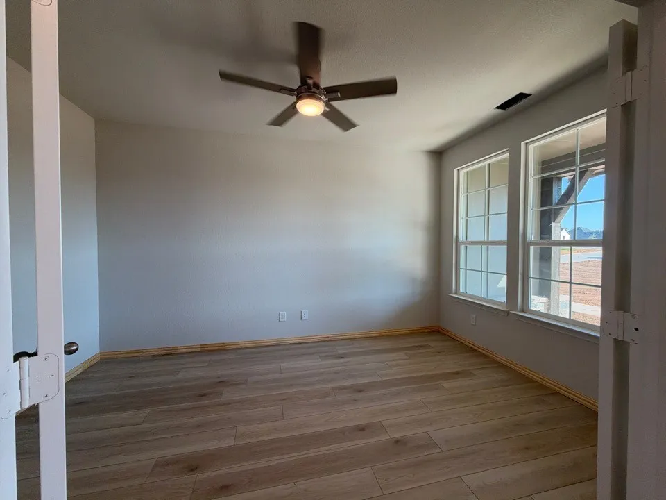 Wood-finish flooring, recessed lighting, and a ceiling fan with integrated lighting
